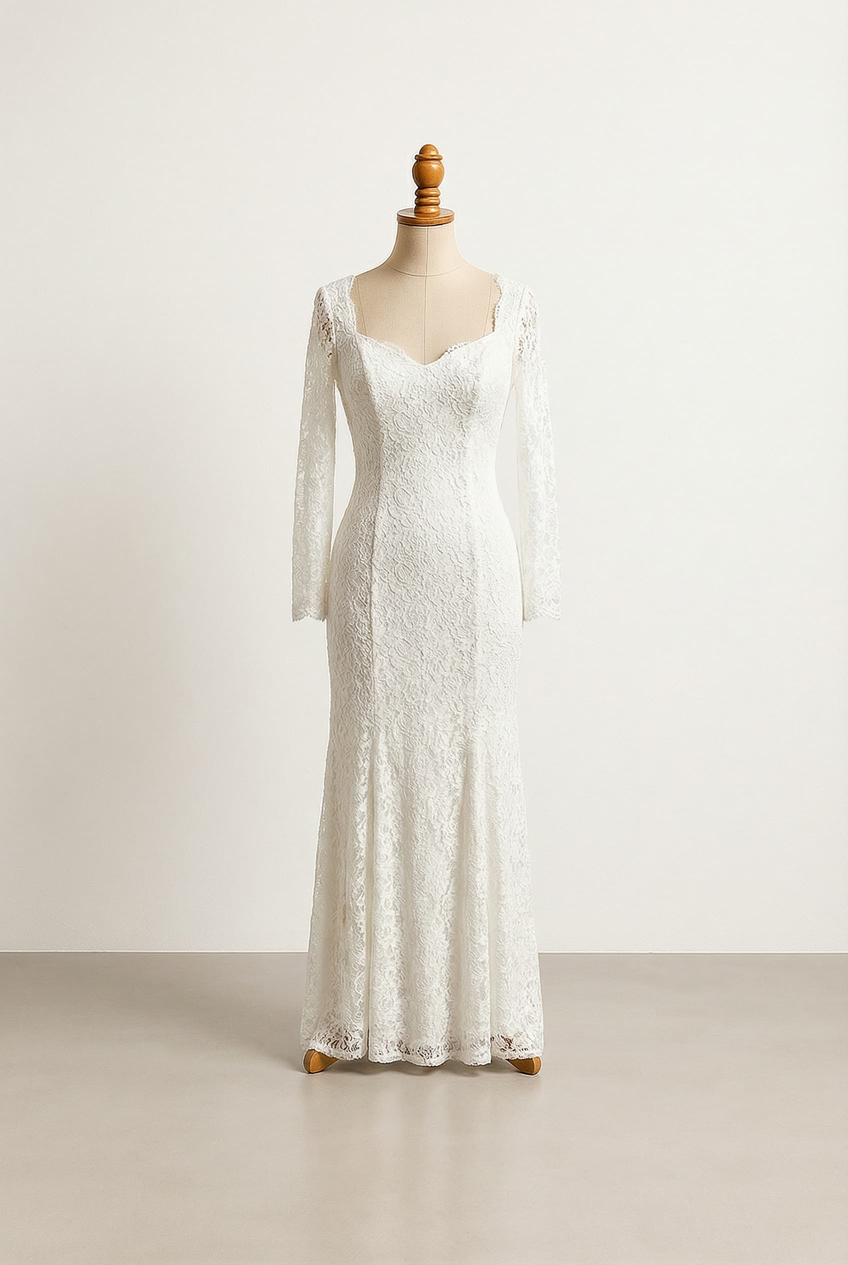 white, floor-length sheath wedding dress with a sweetheart neckline, long sleeves, and delicate lace throughout