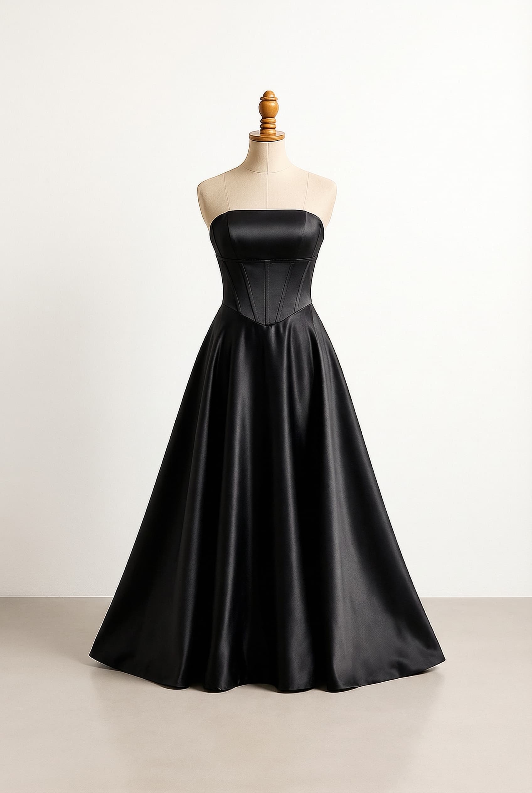 A balanced prom dress black strapless silk full length dress with the right side high and the left long straight across neckline with a basque waistline and a black satin fabric Boning in the top part and an asymmetrical skirt