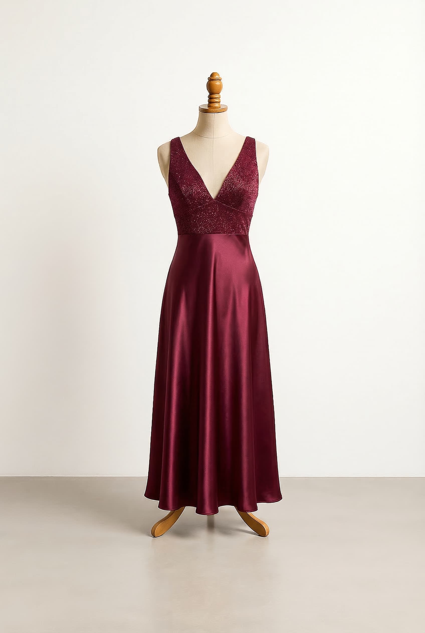 Deep red wine maxi dress with straight corset vibe neckline not covering the neck chest or back with glitter up to mid waist and satin for the rest of the dress, fitted