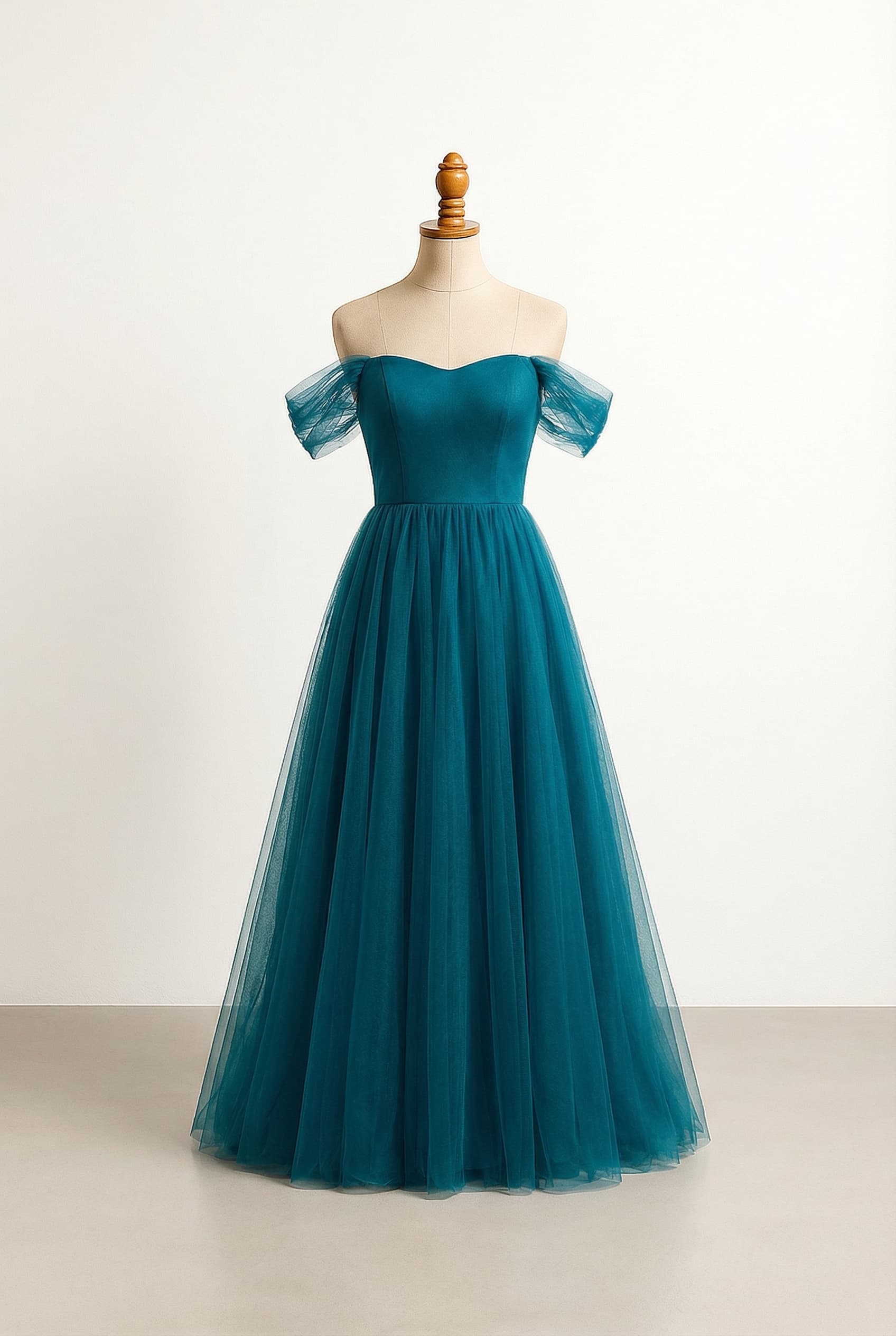 Glamorous prom dress in deep ocean turquoise with a sweetheart corset bodice, A-line silhouette, delicate off-shoulder tulle sleeves, and a flowing tulle overlay on the skirt with a left-side split. No additional embellishments.