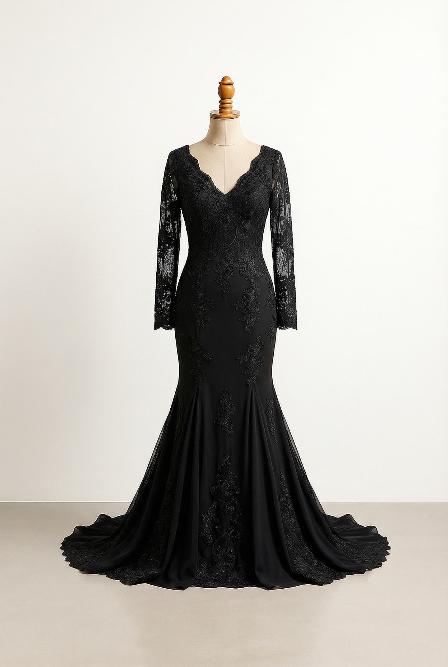 mermaid dress with lace details, relaxed lace sleeves with a fine, almost invisible finish at the wrist, and a slit in the skirt