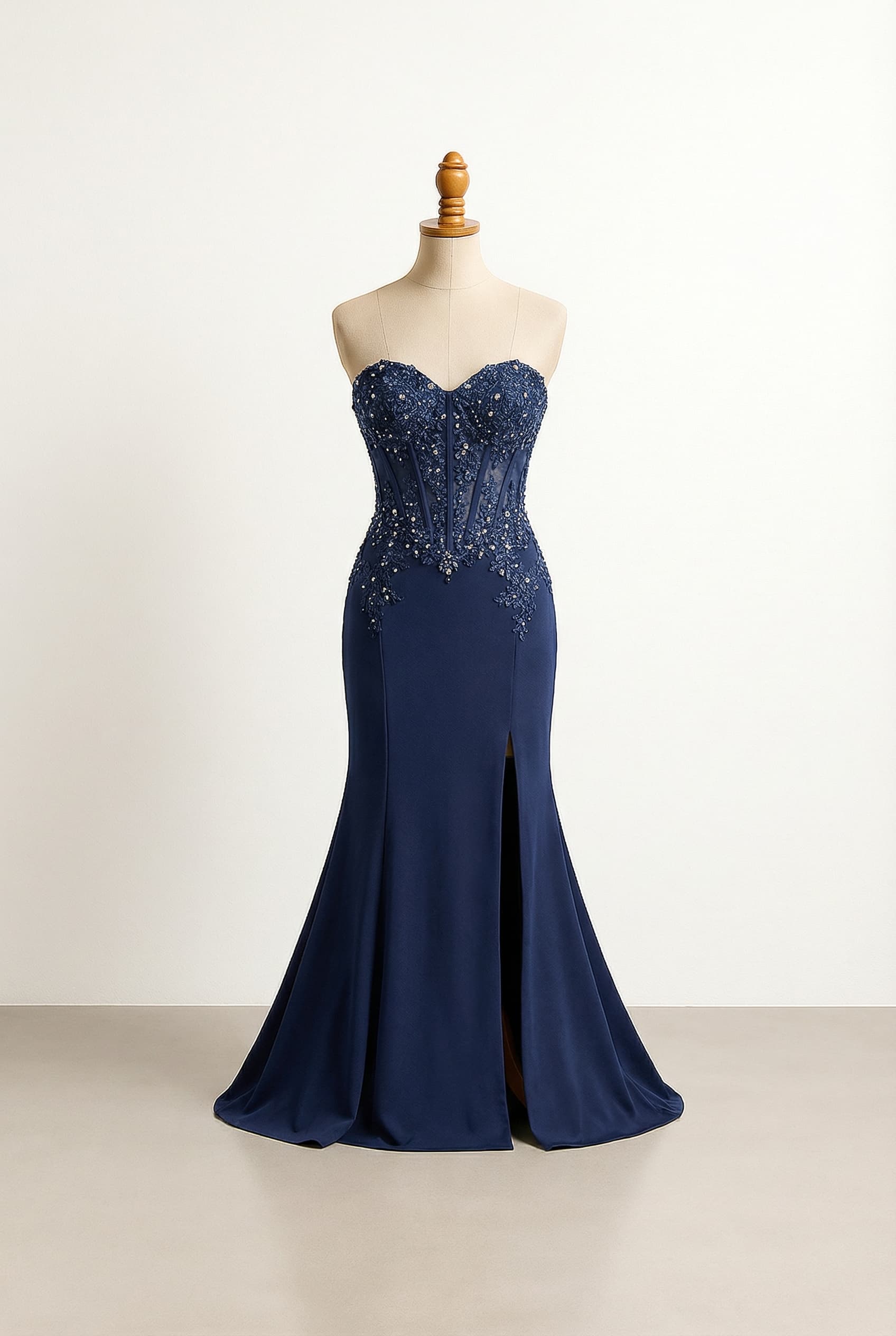 Glamorous dark blue mermaid prom dress featuring a corset bodice that stops slightly above hips with built-in push-up, jewel and lace embellishments, and a daring thigh-high slit.