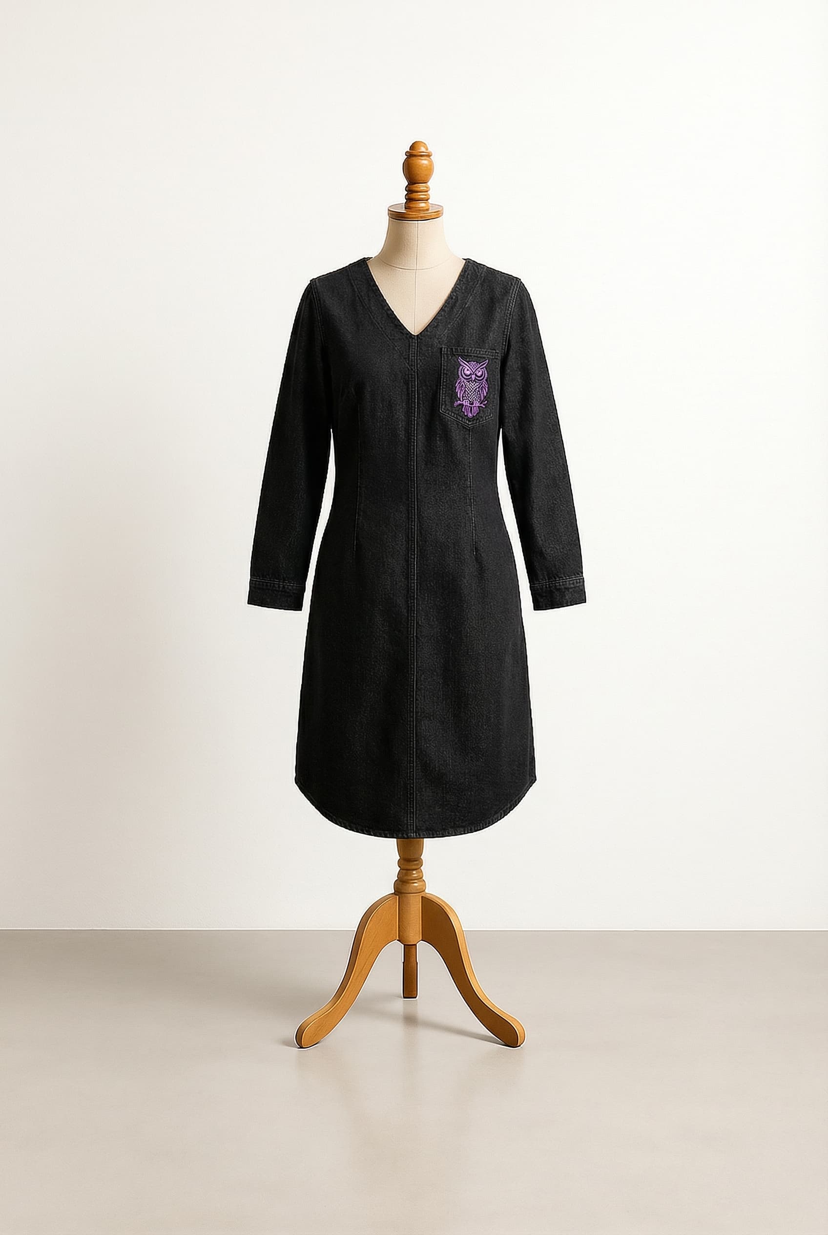 black denim dress with embroidered purple owl on chest pocket and V-neckline