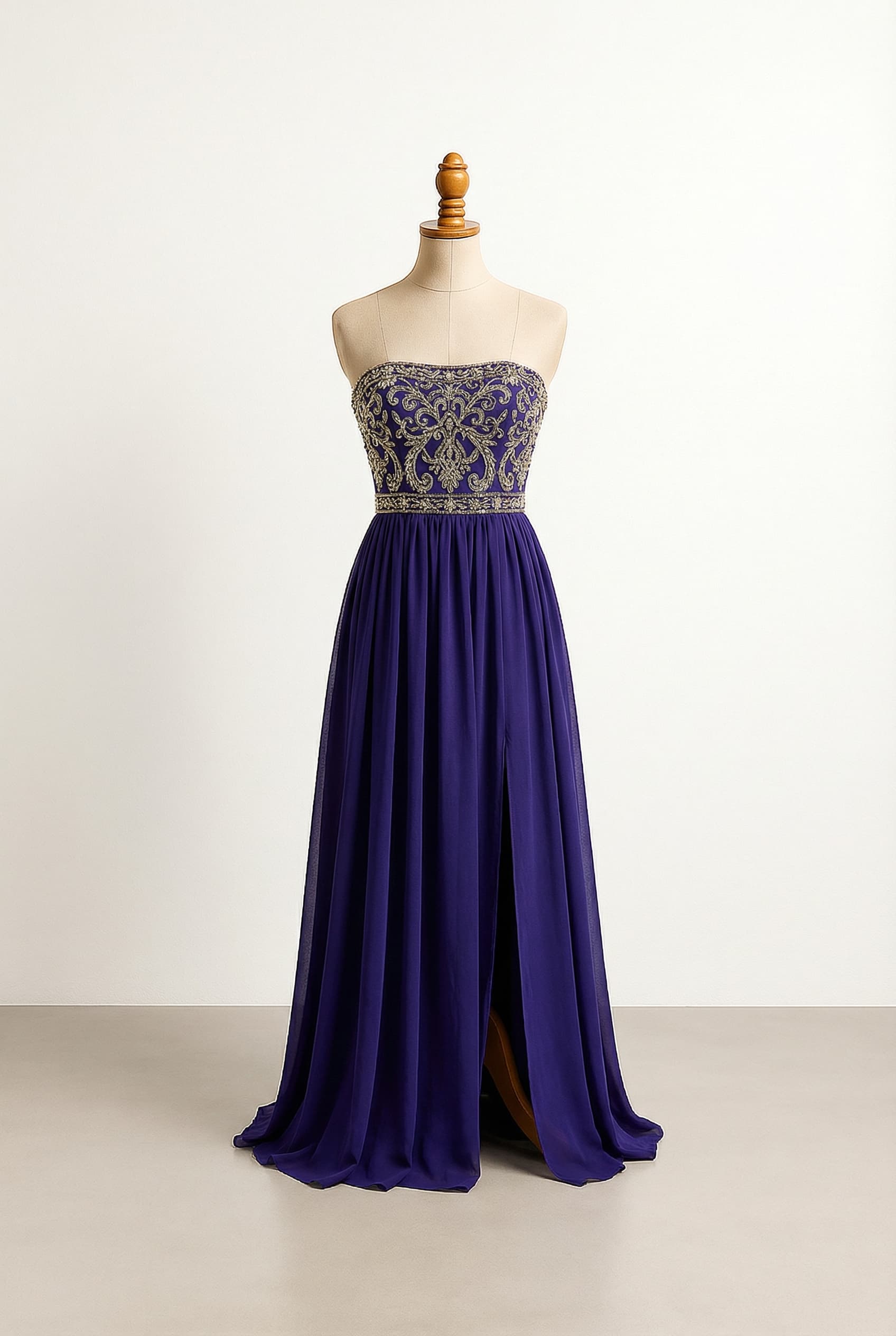 Glamorous prom dress with a strapless, see-through corset bodice featuring gold or silver embellishments, a defined natural waist, and a flowy, floor-length silk chiffon skirt with a high slit.