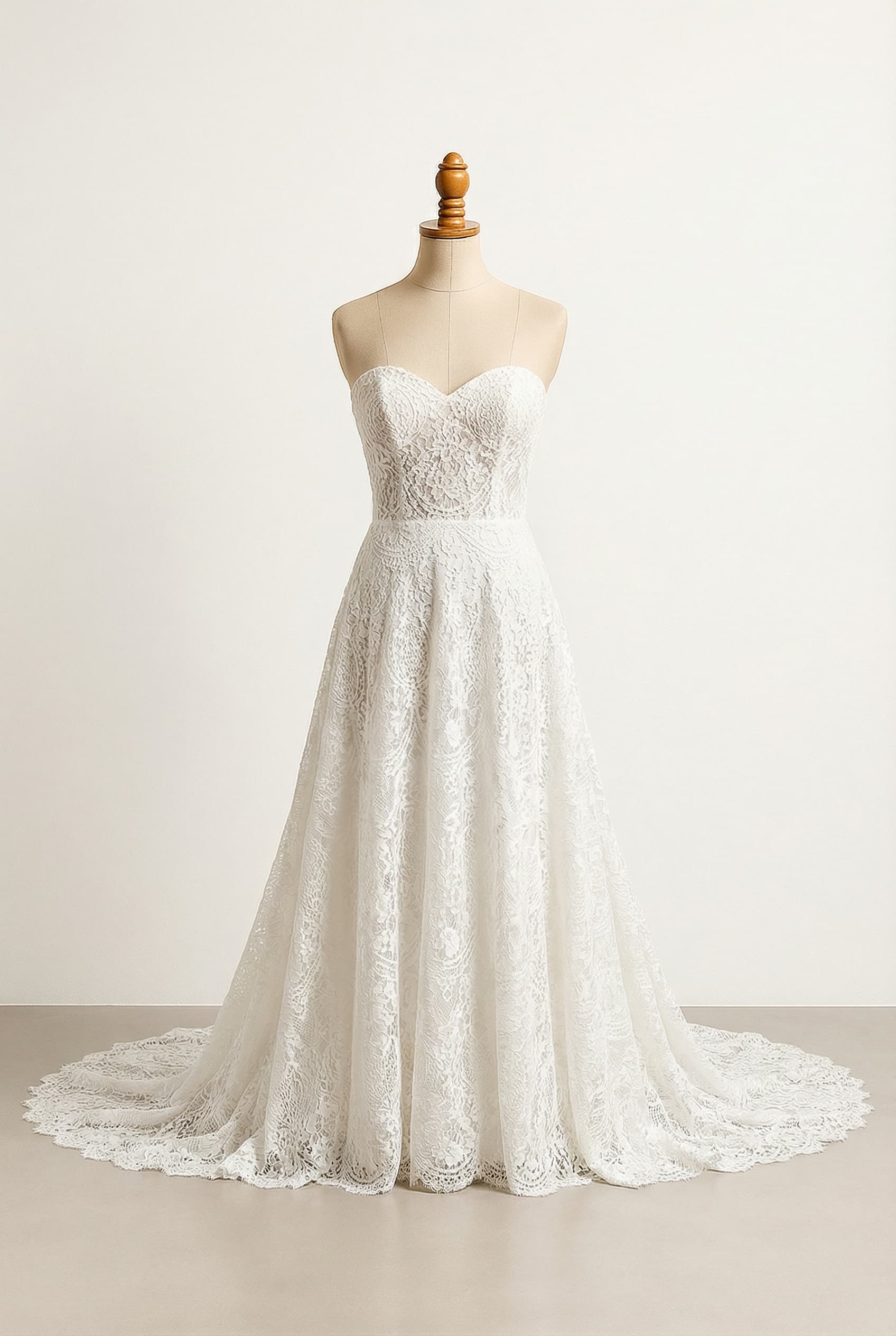 Wedding dress with a sweetheart neckline, champagne color, and a cathedral train.