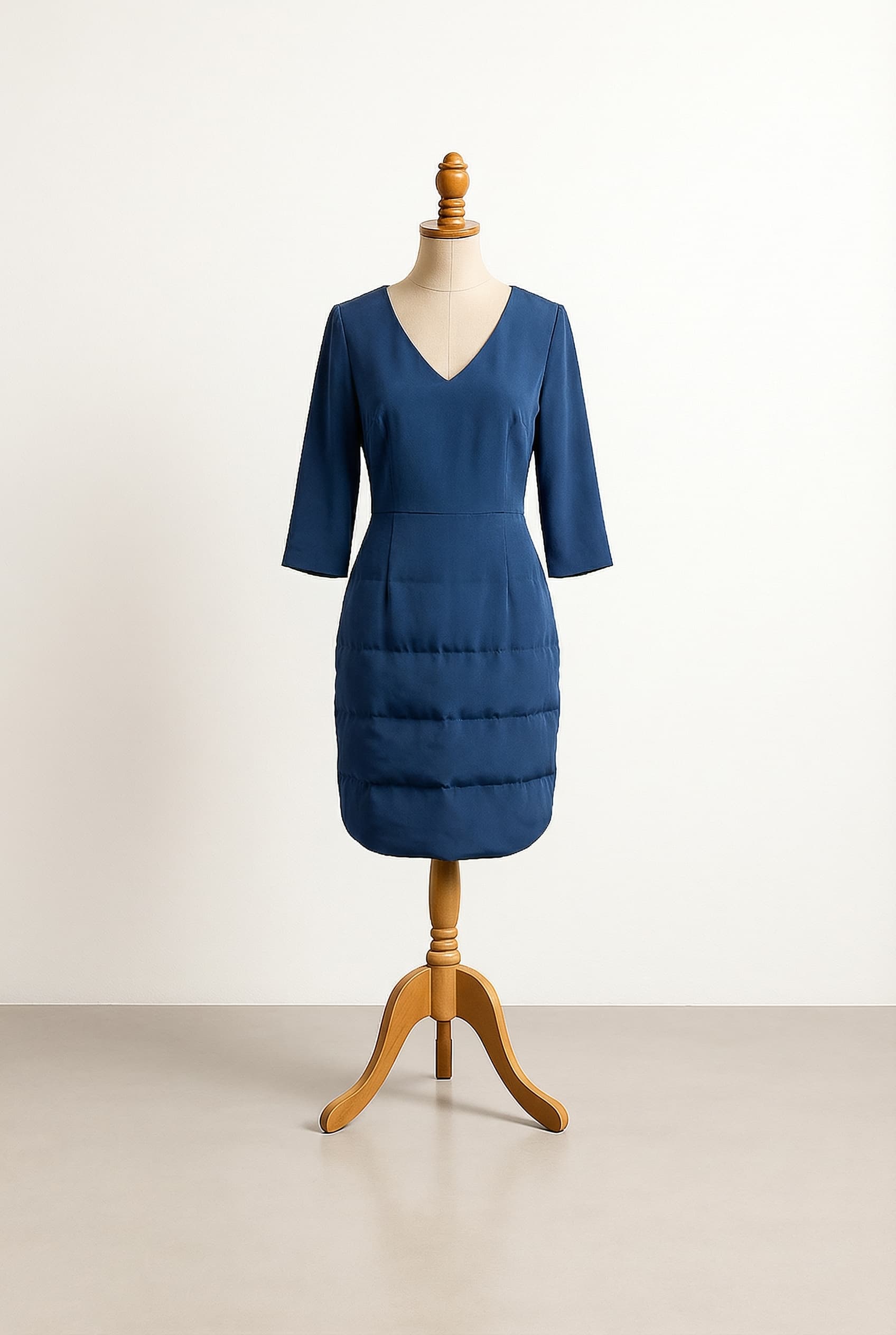 I want a balanced formal dress in deep blue with a skirt that has puffer detail and is shorter than knee length, suitable for summer