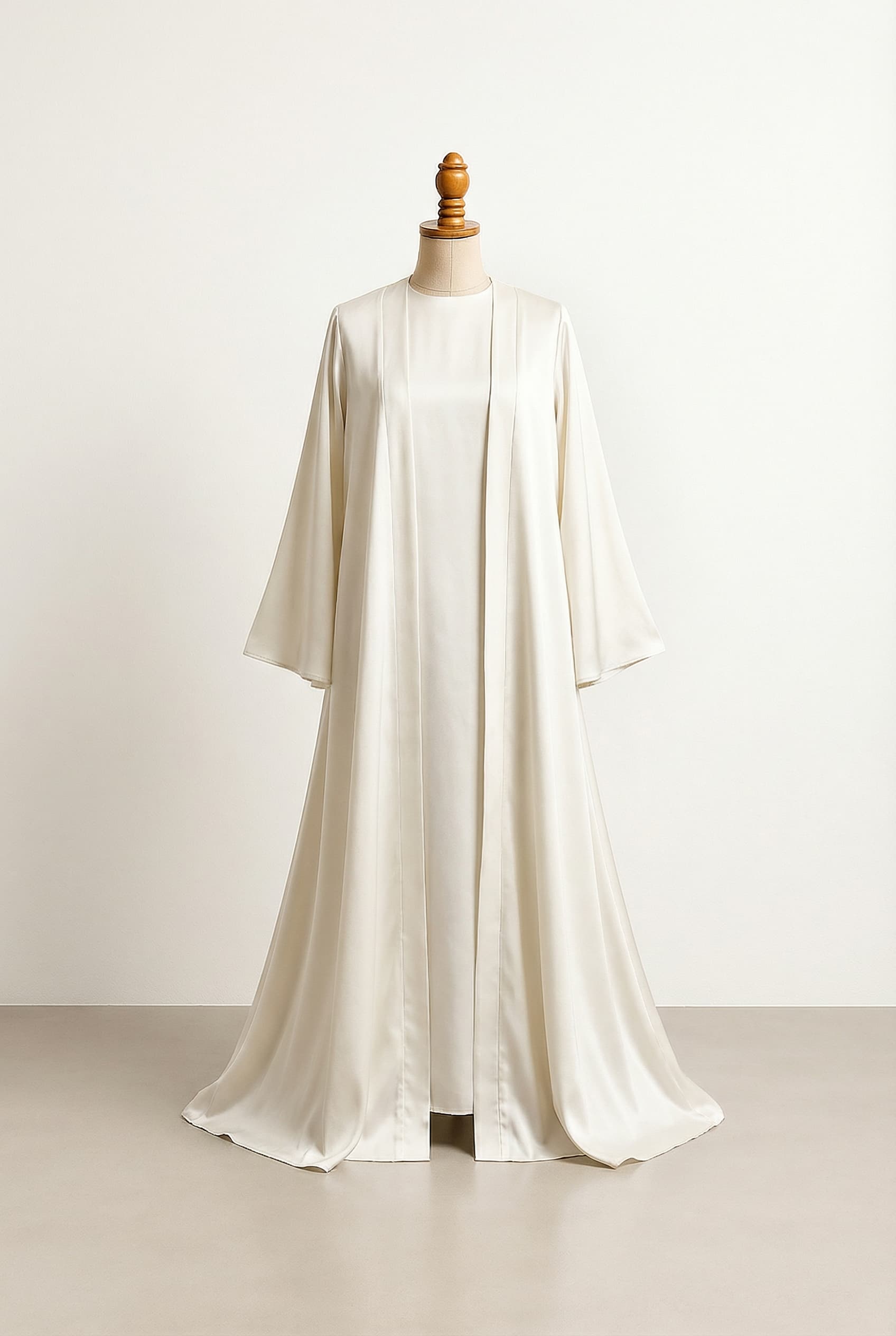 Modest style with full coverage, higher necklines, and sleeves. Make an abaya dress, simple and modern. Make the sleeves flowy, and the abaya has to have 2 pieces. The first one is a dress, and the second is a cover. all the same length