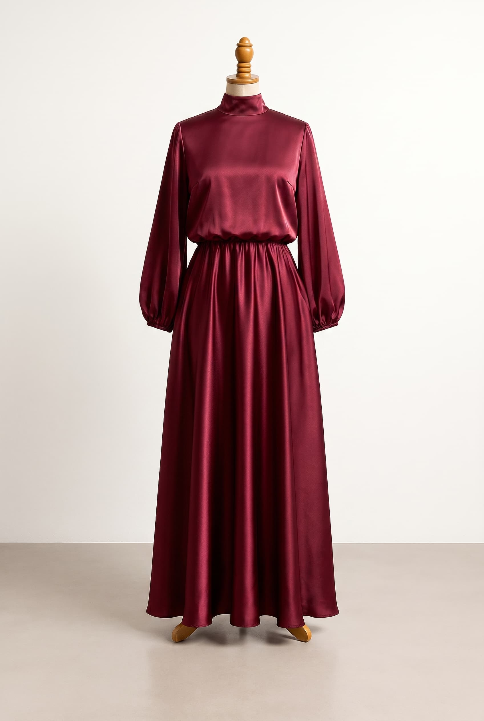 I want a modest formal dress in Burgundy that is light weight and flowy with pockets and a high neckline featuring a loose bodice in a silky smooth fabric with Bishop sleeves and a Floor length hemline, A–Line silhouette.