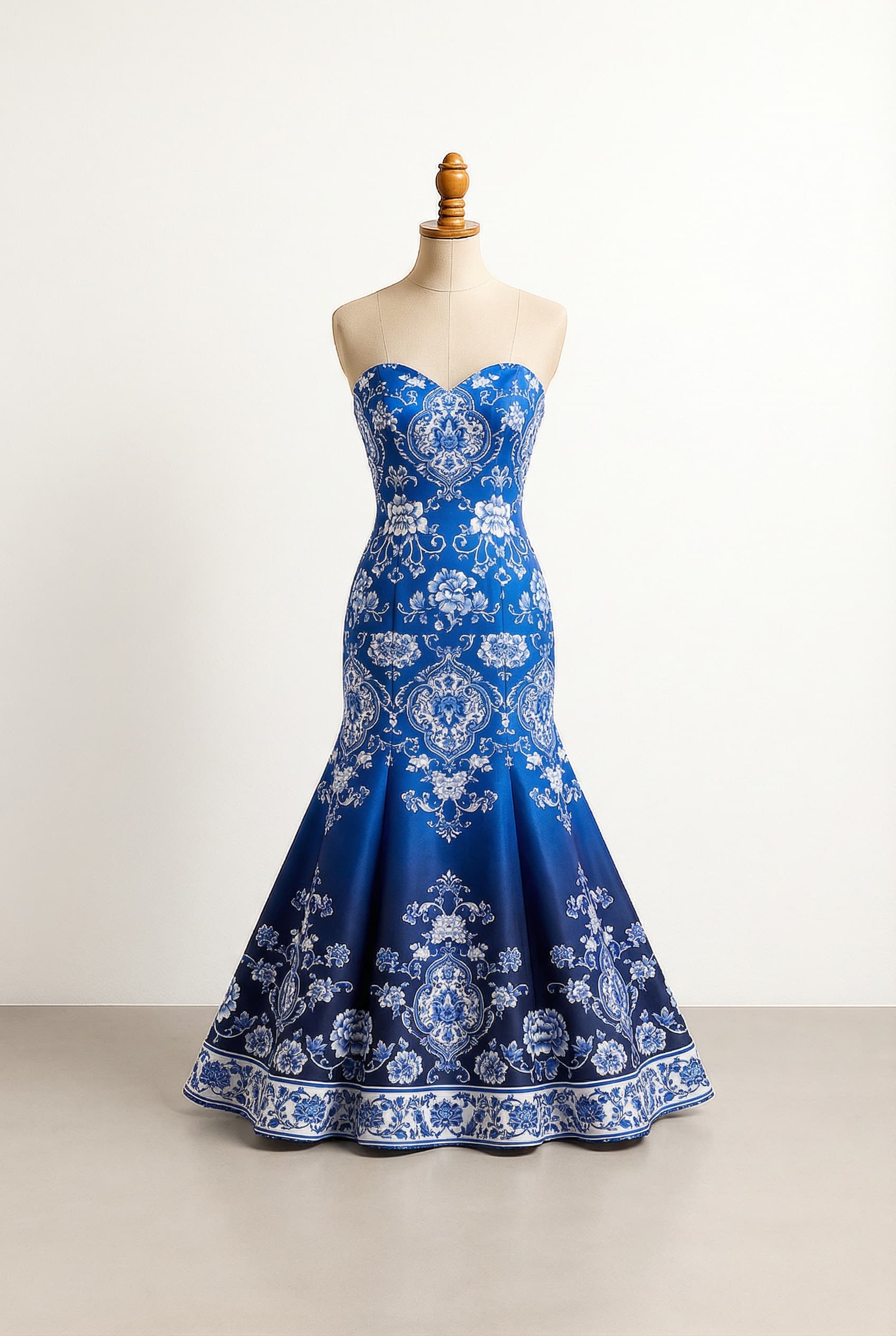 Royal Blue to Navy China pattern prom dress with a modest V-neckline and delicate thin straps, on a crisp white background with a balanced floral pattern density, in a Fit & Flare silhouette.