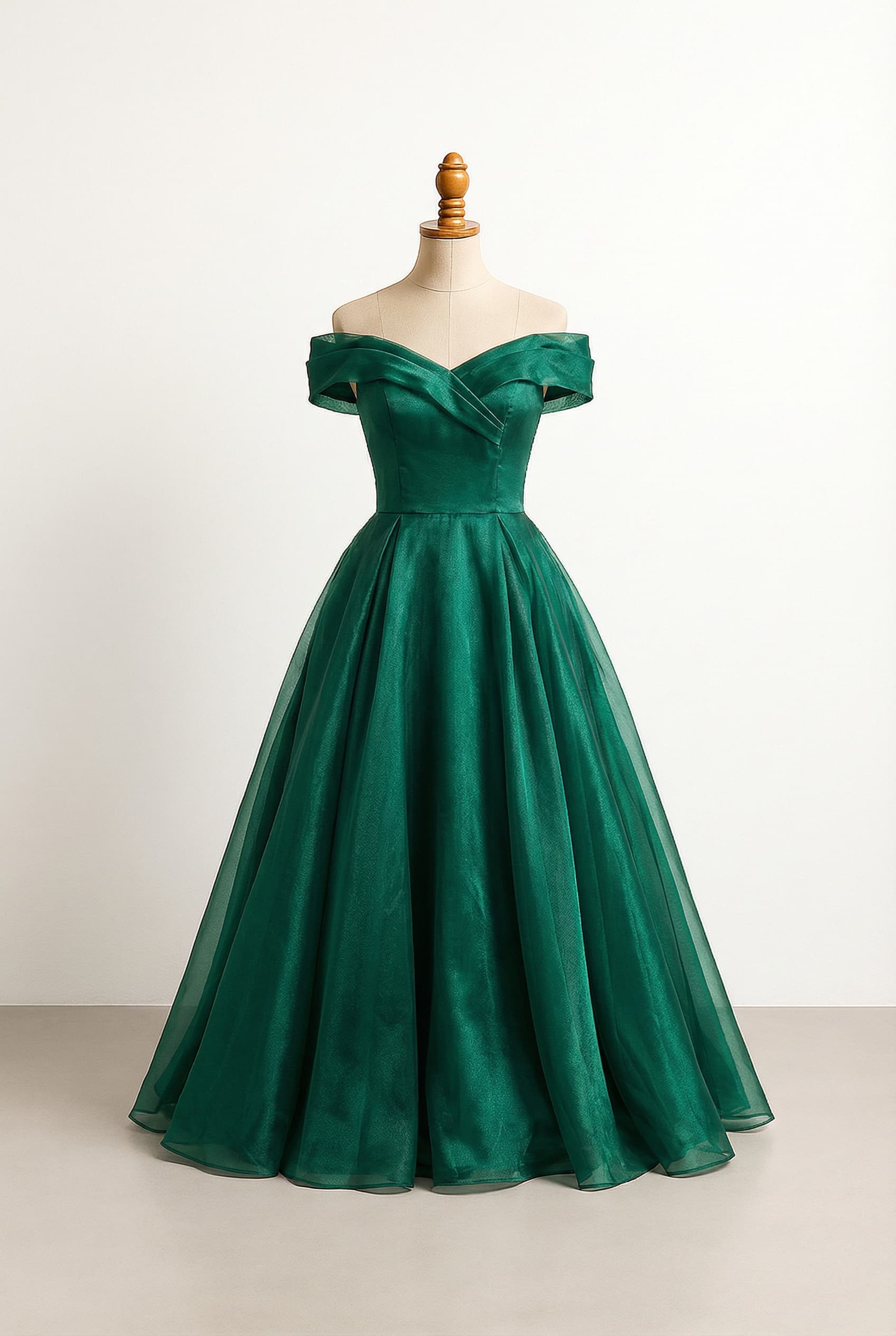 A glamorous Emerald Green prom dress, floor-length, featuring a fitted off-shoulder bodice, a defined waistline, and a voluminous, multi-layered organza ball gown skirt.