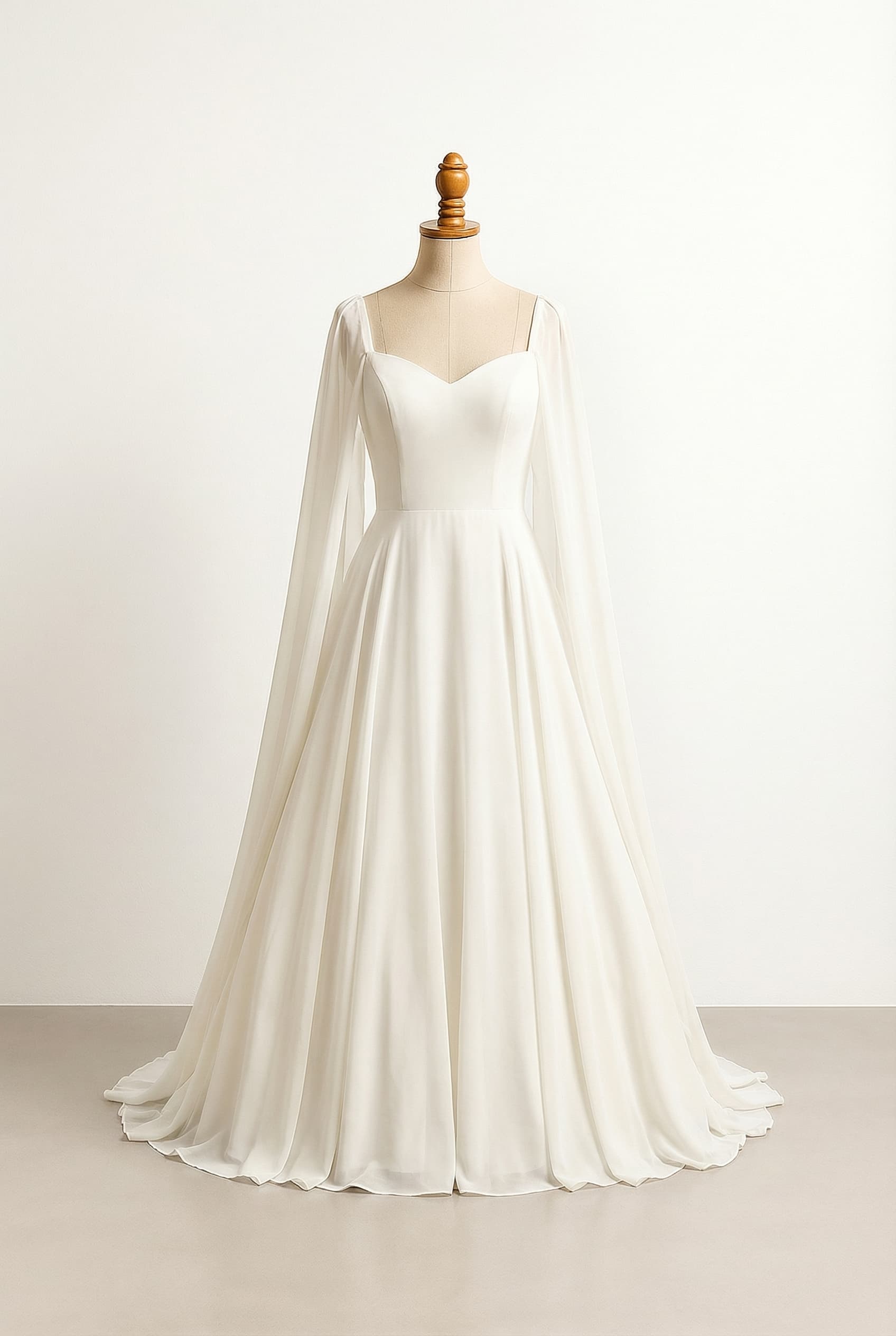 Wedding dress with cape sleeves and a ball gown silhouette in White