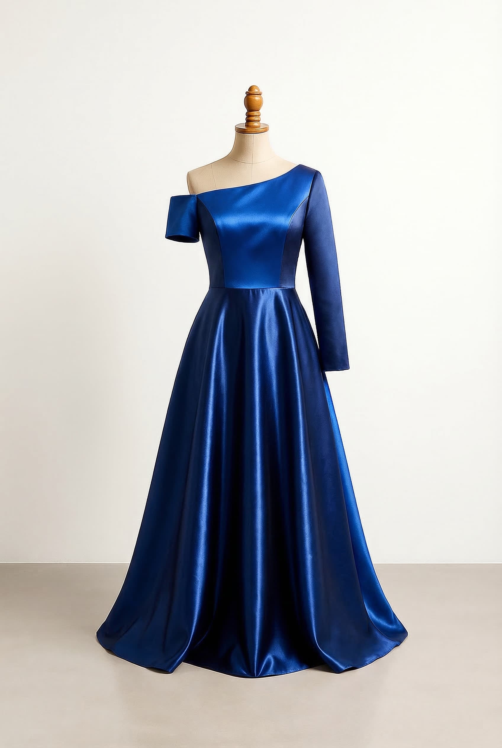 Prom dress in mixed dark blue and royal blue satin fabric with a fluffy A-line silhouette one short sleeve and one long sleeve and a creative design