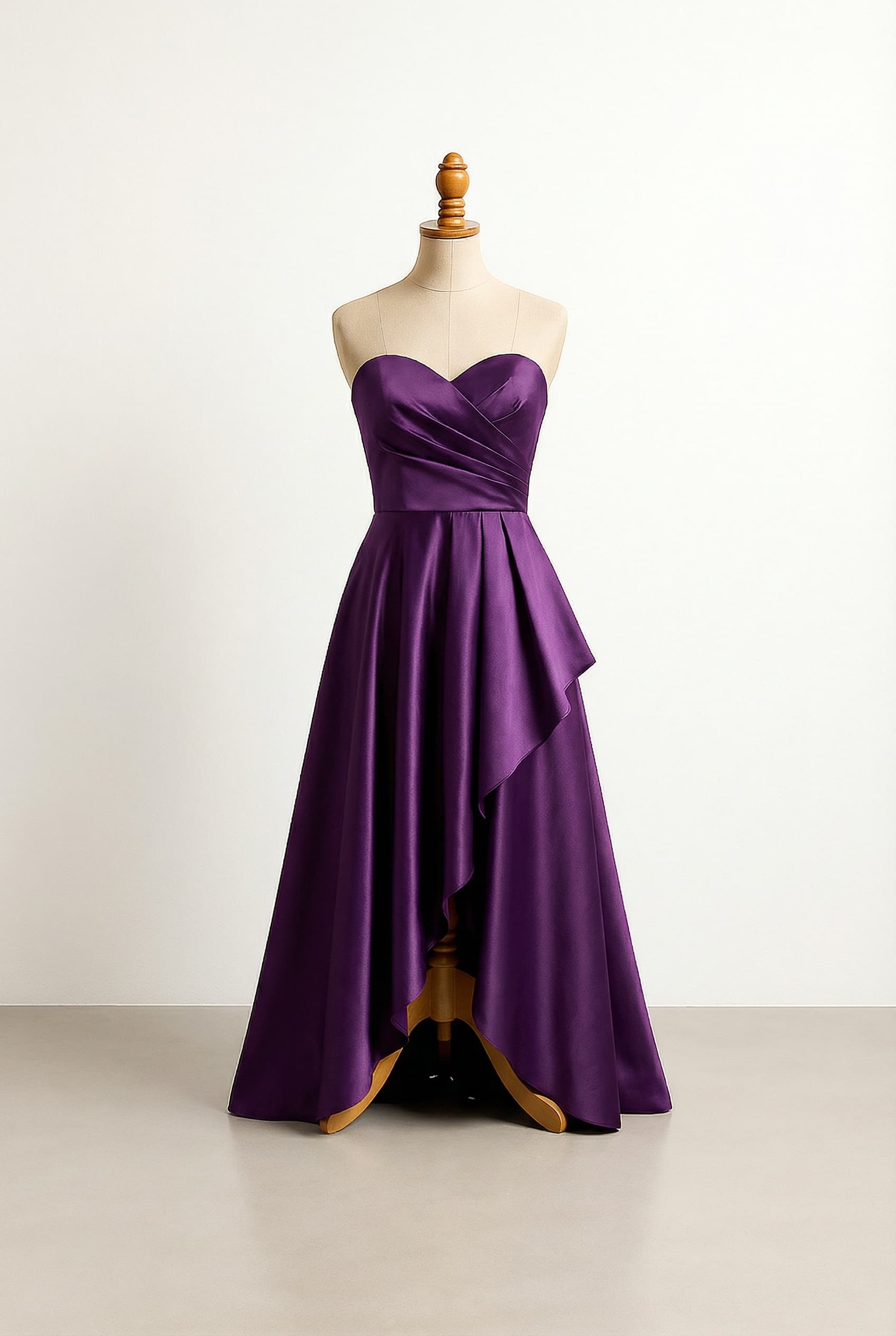 Glamorous A-line prom dress in regal purple Duchess satin, featuring a sweetheart neckline, asymmetrical draped bodice, and a high-low skirt.