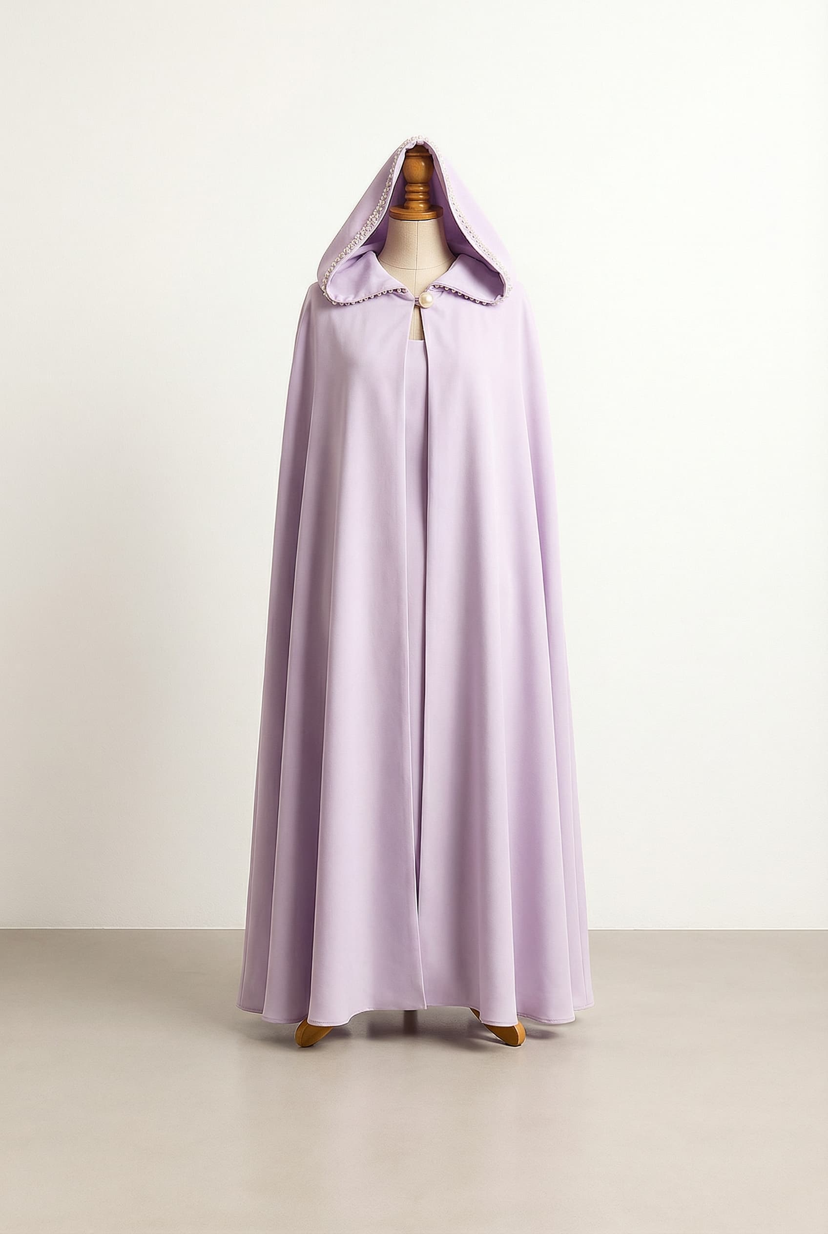 Light lilac dress with a matching hooded cloak, featuring a pearl button connection and light beading around the front of the hood.