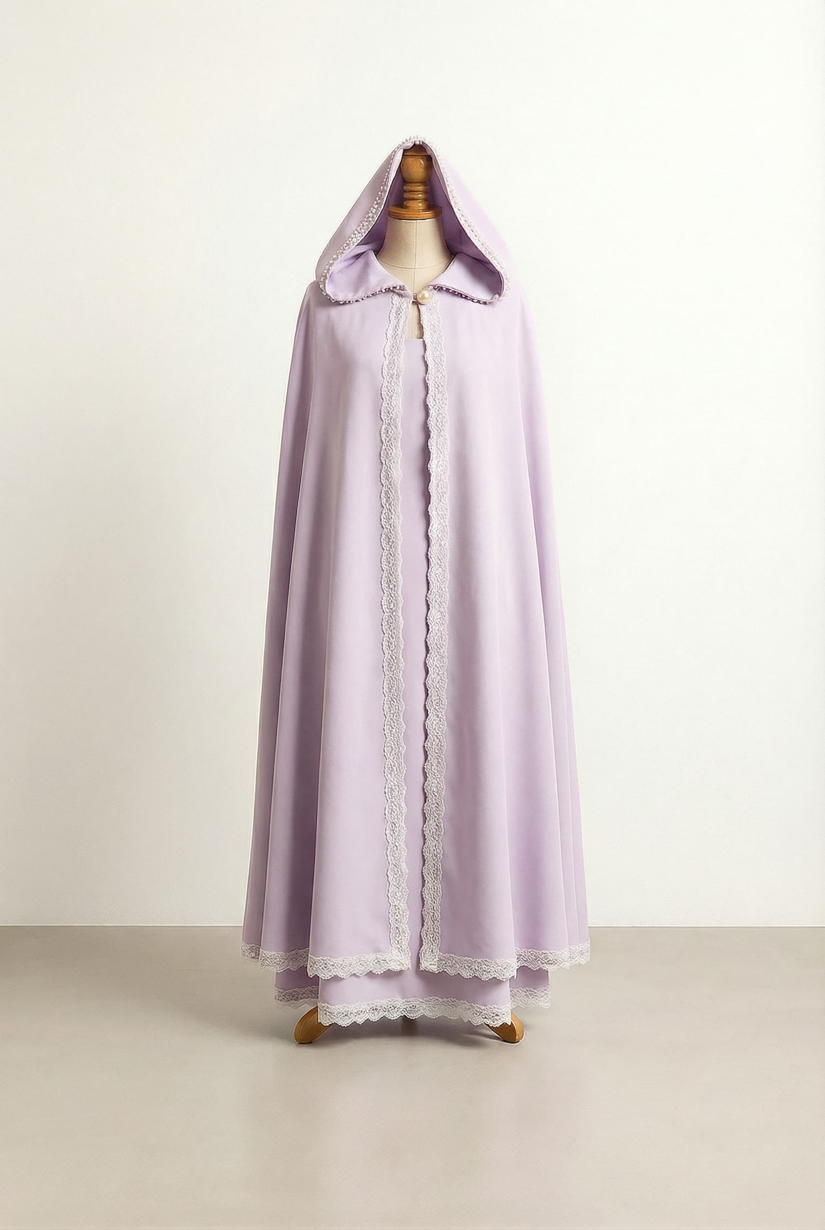 Light lilac dress with a matching hooded cloak, featuring a pearl button connection and light beading around the front of the hood.; Add delicate lace