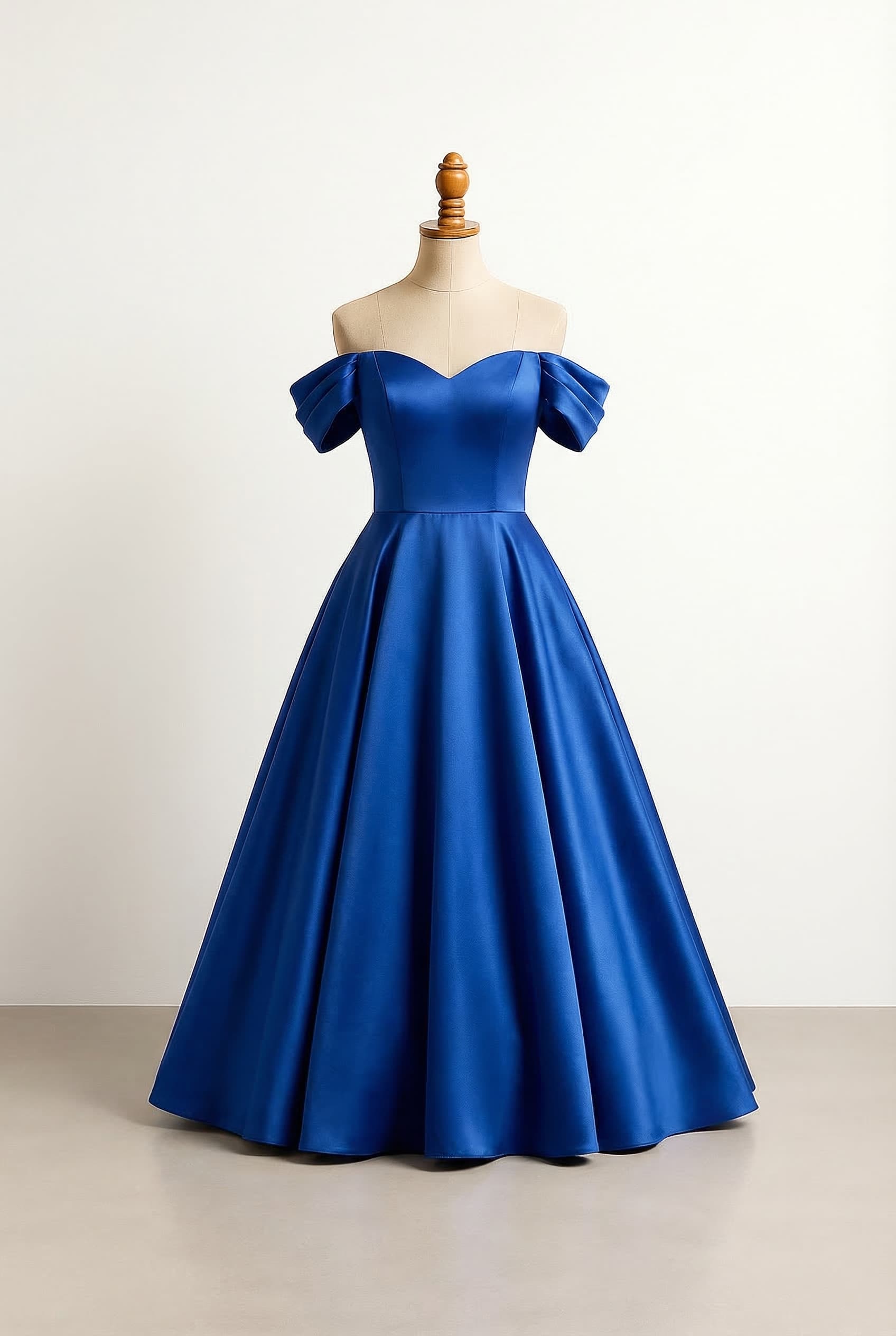 A flowy ballgown dress in royal blue with a sweetheart neckline and off-the-shoulder sleeves