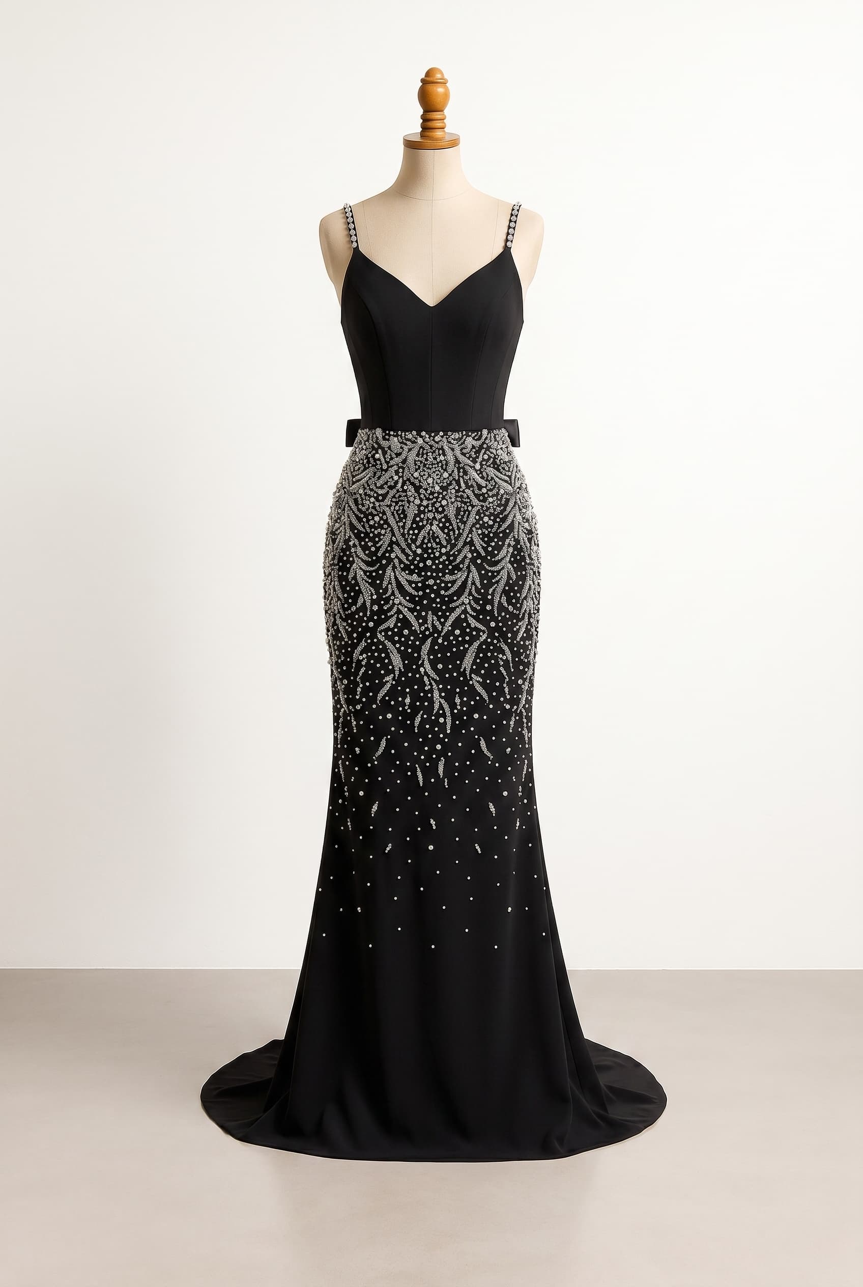 I want a balanced prom dress with a plain black corset bodice and skinny straps with gemstone embellishment, a black skirt with a silver designed gradient pattern being more noticeable at the top of the skirt and waist, with a scattering pattern slowly fading down towards the floor, floor length with a train, fitted silhouette, with a classic ribbon tie