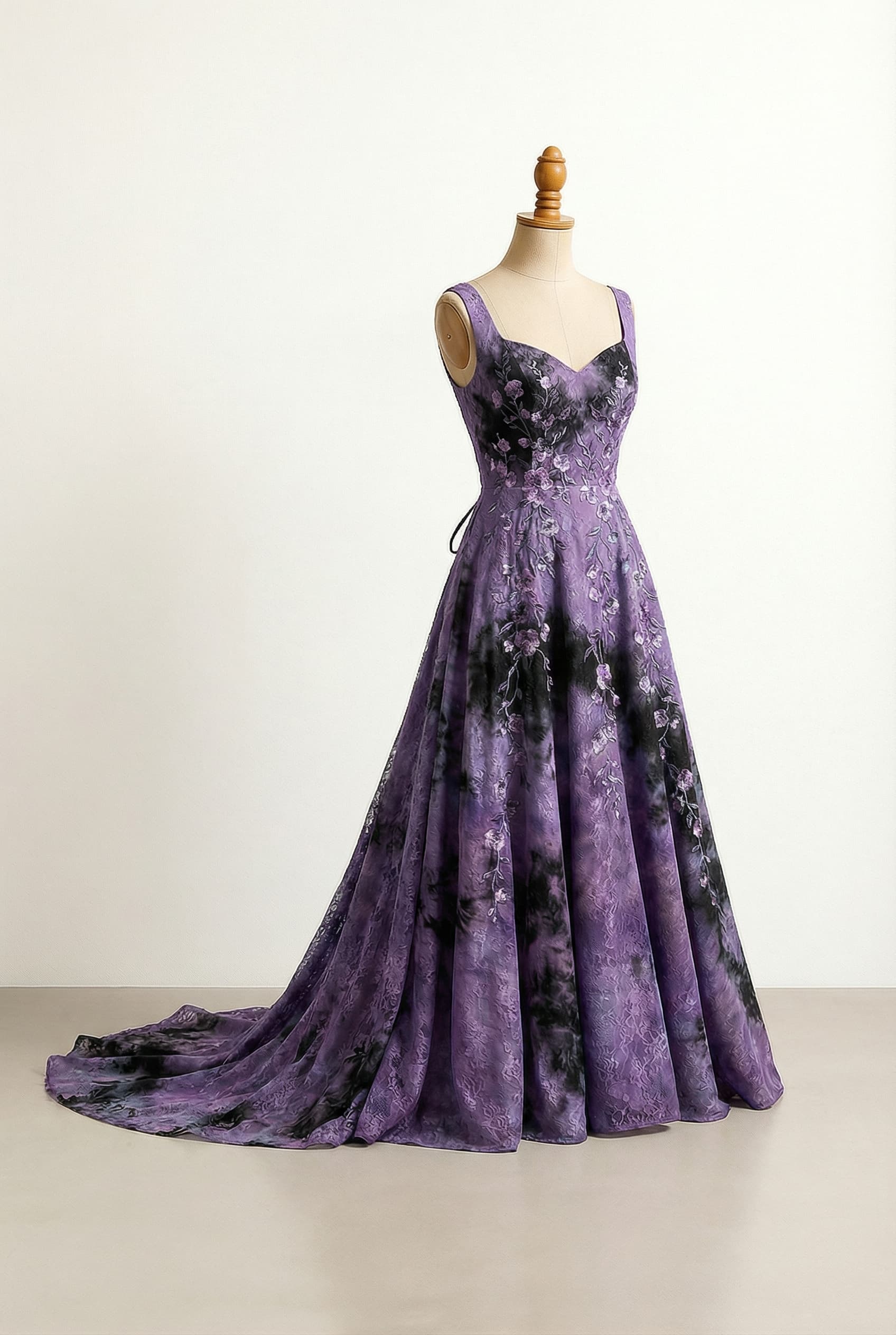 A romantic floor-length A-line wedding dress with organically intermingled purple, turquoise, and black colors, featuring a sweetheart neckline, long sleeves, delicate floral embroidery with black accents scattered across the bodice and continuing down the front of the skirt, and a graceful lace-up back.; Add a longer train, make it lace, remove the sleeves and turquoise