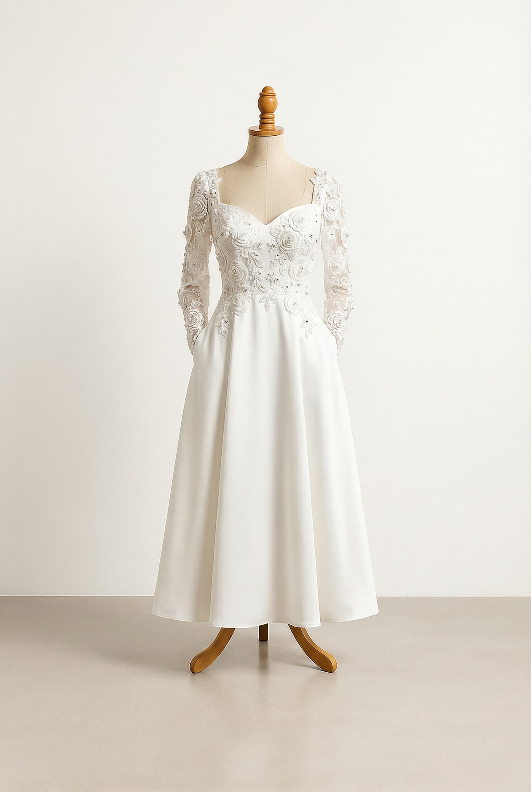 A romantic wedding dress with elegant details, a regular waist, lace appliques of roses, pearls and crystals accents on the bodice and sleeves, and pockets.