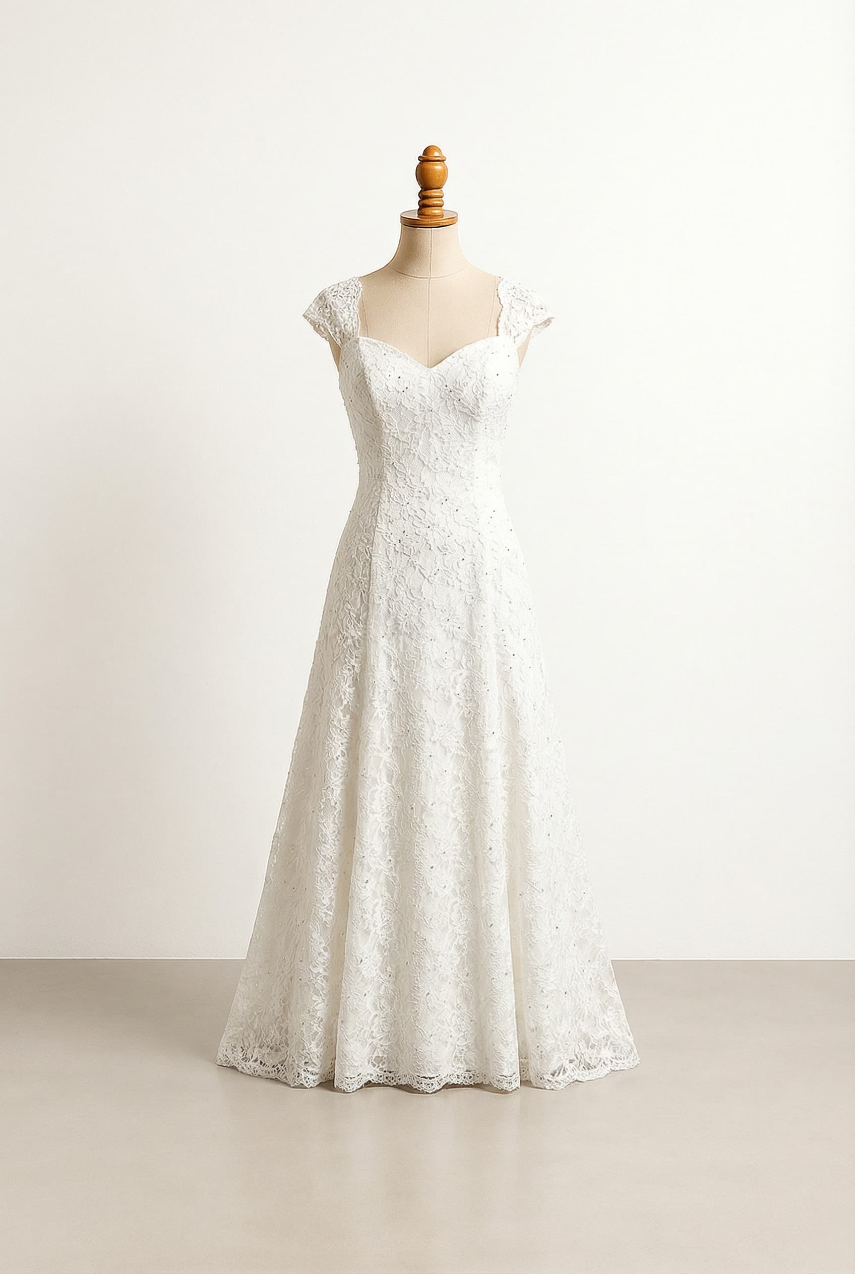 A romantic wedding dress with elegant details, featuring classic lace and subtle beading. A classic lace pattern with a touch of delicate beads on the bodice.
