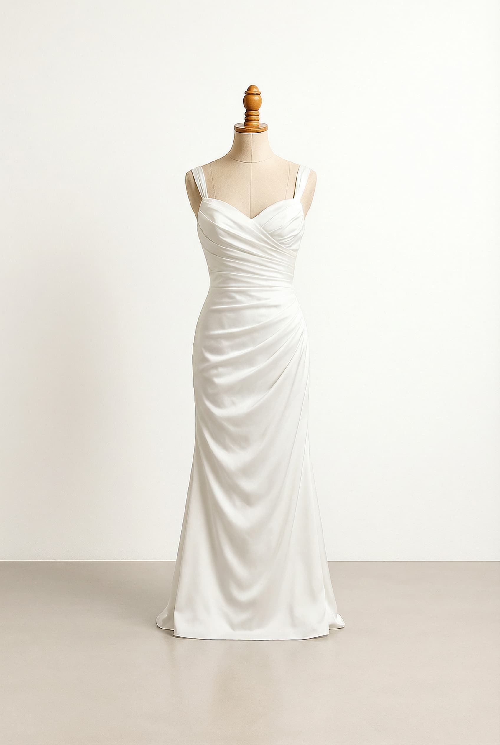 White floor-length wedding dress with a sweetheart neckline, delicate straps, and a ruched bodice.