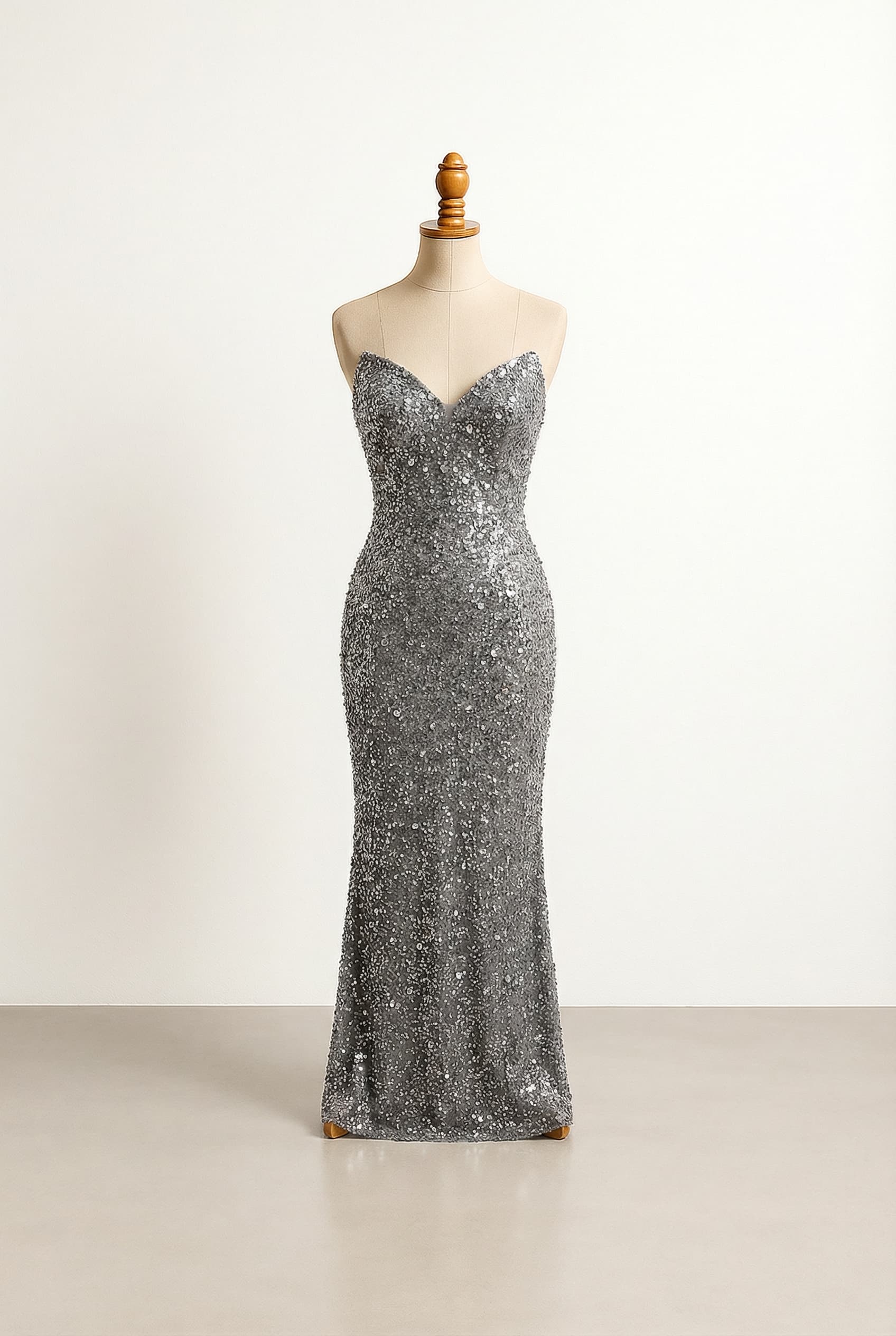 Glamorous prom dress with a tight-fitted silhouette, elegant grey color, shimmering sequin diamonds, a strapless V-neck, floor-length, designed to stand out for an African American girl.