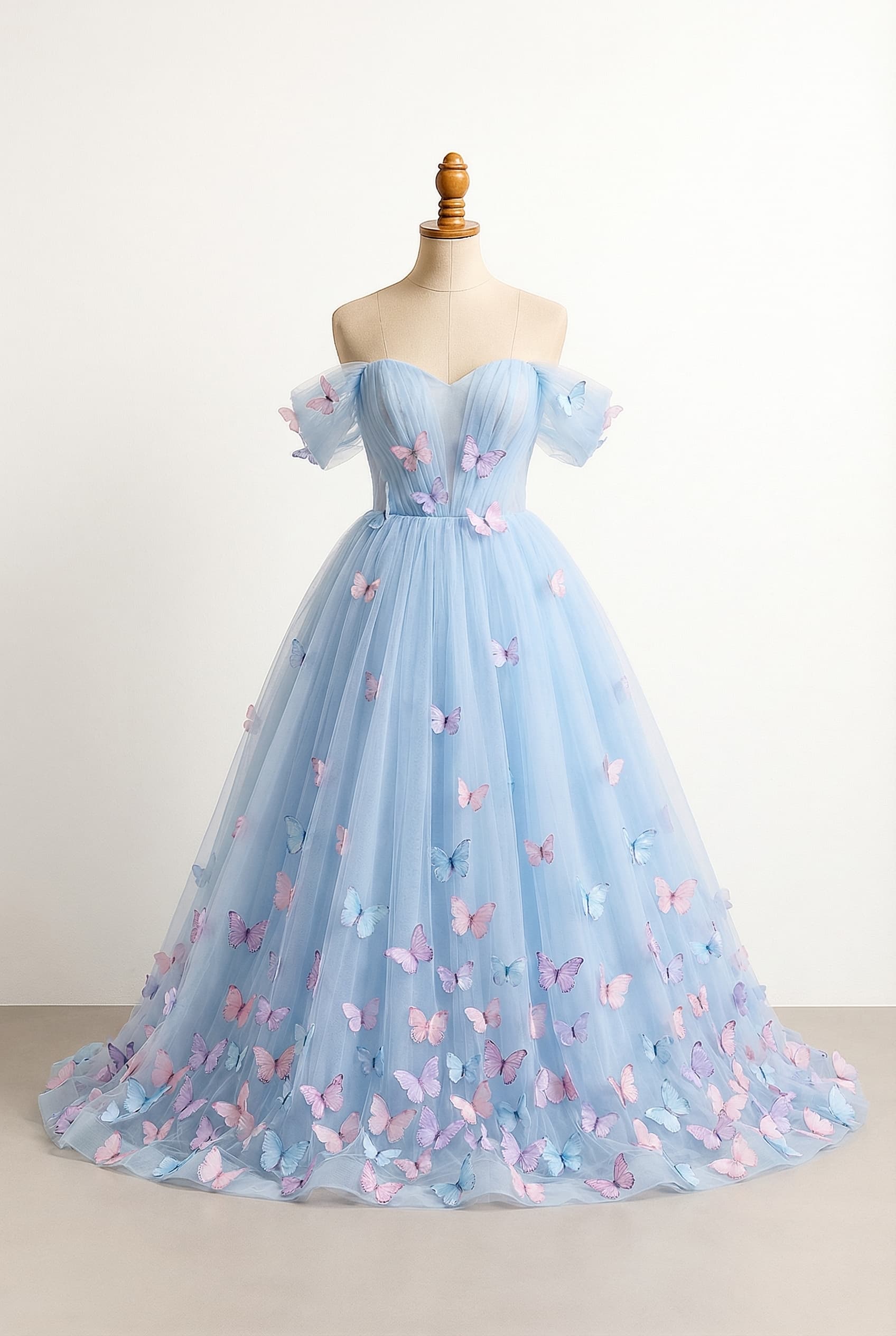 balanced prom dress ball gown length with a sweetheart neckline and off the shoulder sleeves pastel blue tulle with a full puffy skirt that has little butterflies at the top and more and more butterflies as you get towards the bottom the butterflies appliques are pastel pink pastel purple pastel blue, horizontal tulle around the bust and tulle sleeves coming from that section