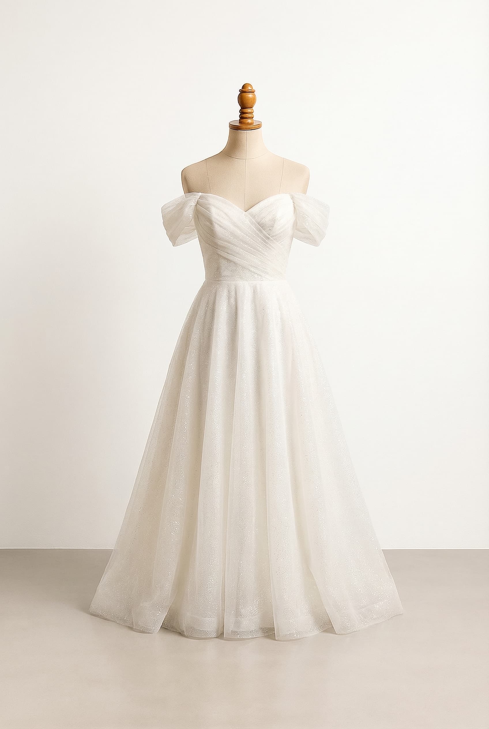 I want a balanced wedding dress A fit and flare off the shoulder dress that captures the night sky within its fabric An ivory organza fabric for the base fabric and a soft glitter tule over top An off the shoulder sweetheart neckline