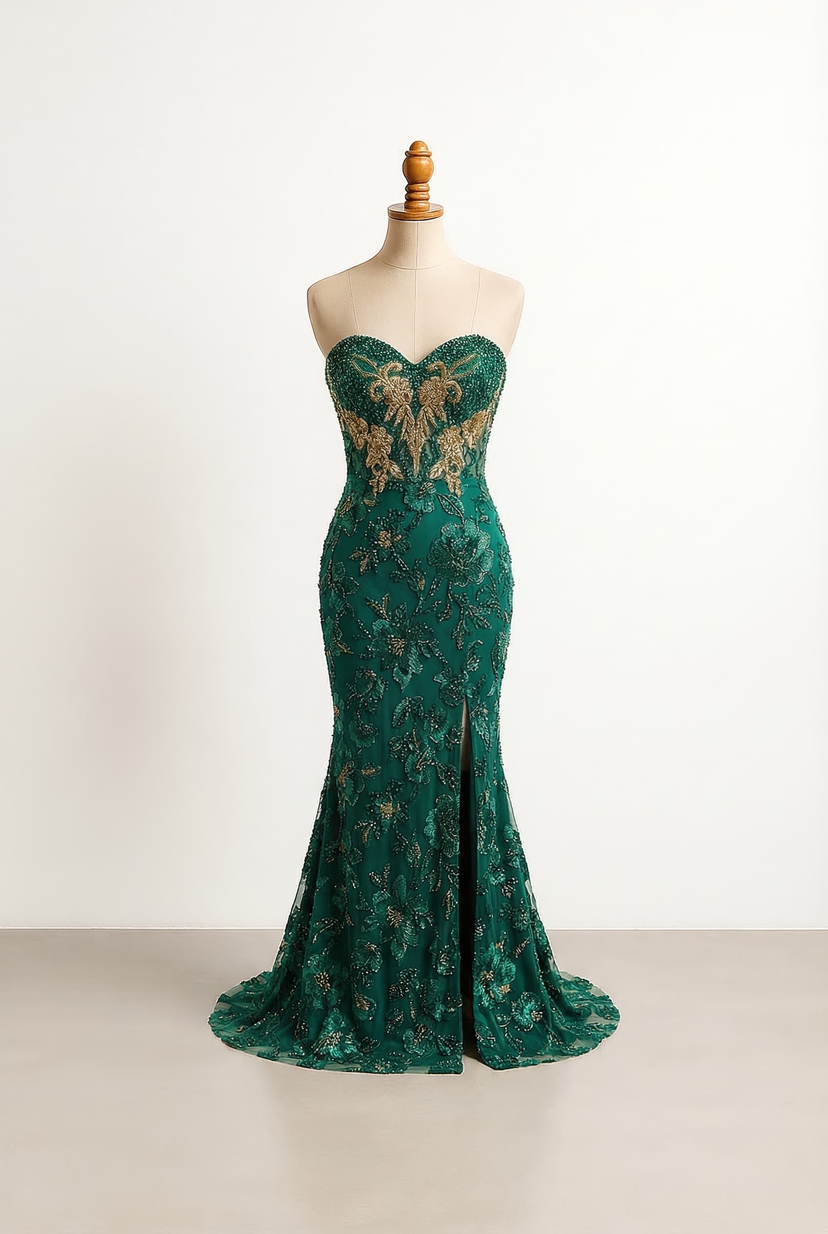 I want a balanced prom dress with an emerald green floral pattern with gold accents on the chest, a sweetheart neckline, and a fully beaded mermaid silhouette with a side slit