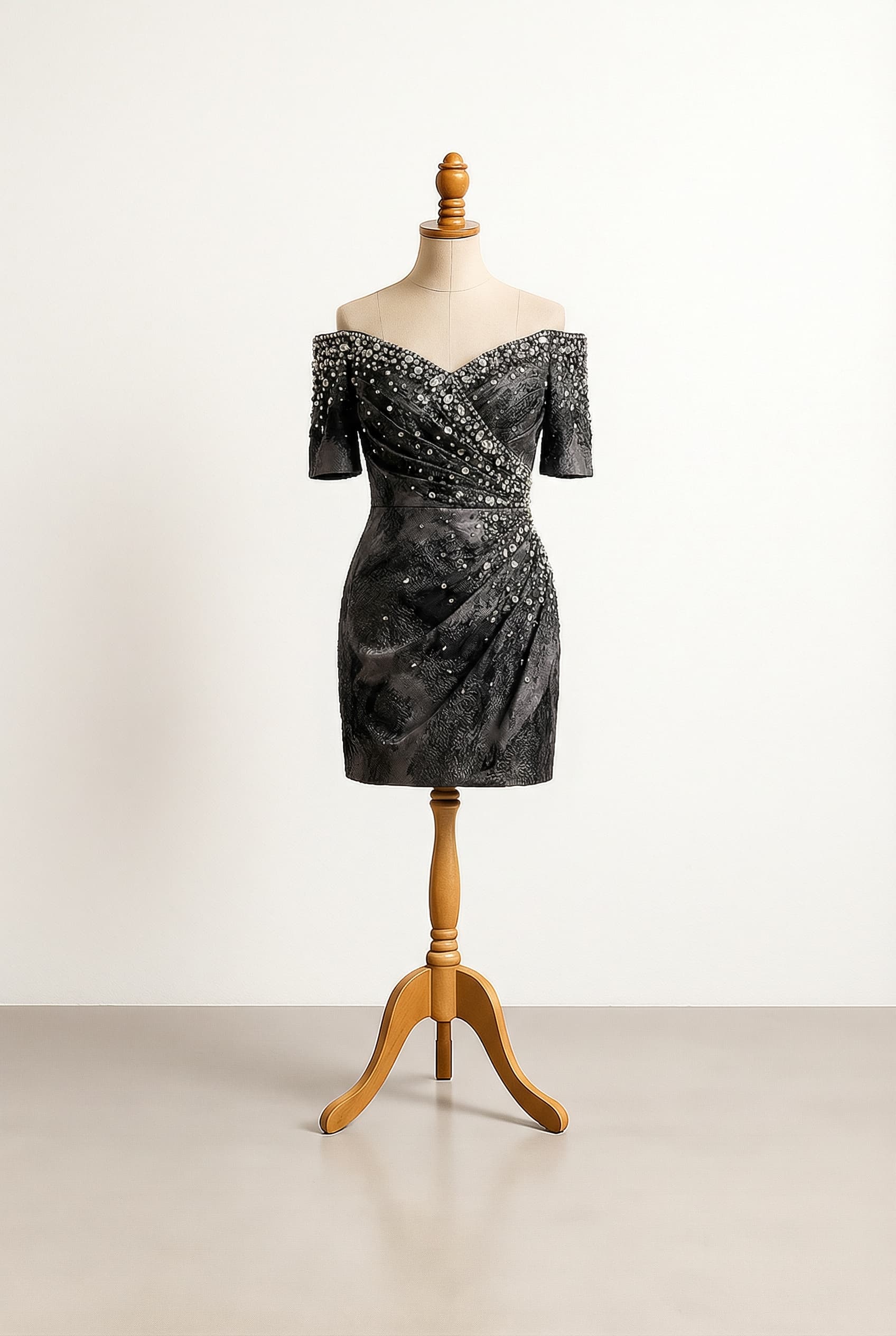 A dress in lighter grayish ash and black colors for contrast, with a gems and bling look, visible in the dark, and off-shoulder short sleeves.