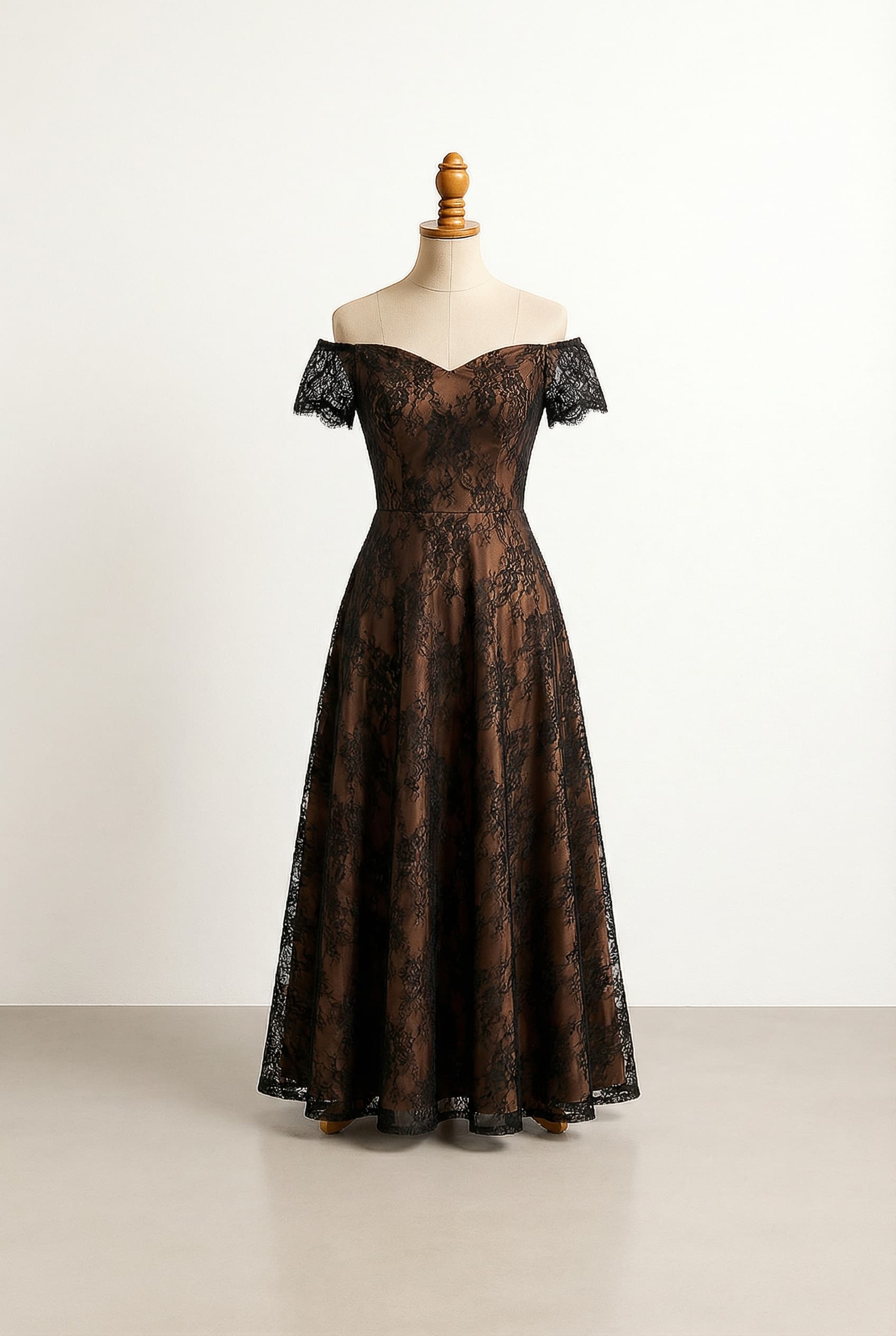 Glamorous prom dress with a brown base and black lace overlay, an A-line silhouette, a simple seam at the waist, and short off-the-shoulder lace sleeves, with no additional embellishments.
