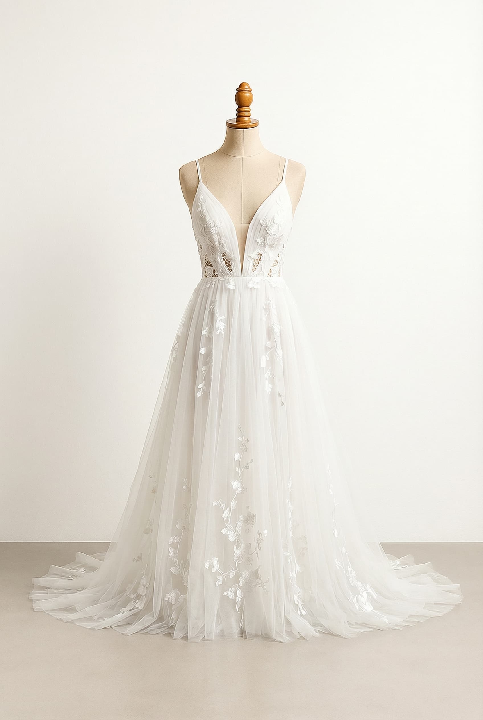 Bohemian wedding dress with cut outs in the front and sides and thin straps with a flowy bottom that is not poofy Similar to Israeli style designers like Galia Lahav Understated on top with flowers flowing on the skirt but not too many flowers so that it doesnt look busy Chapel - Slight train 1-2 feet past feet, Plunge - Deep dramatic V-neck