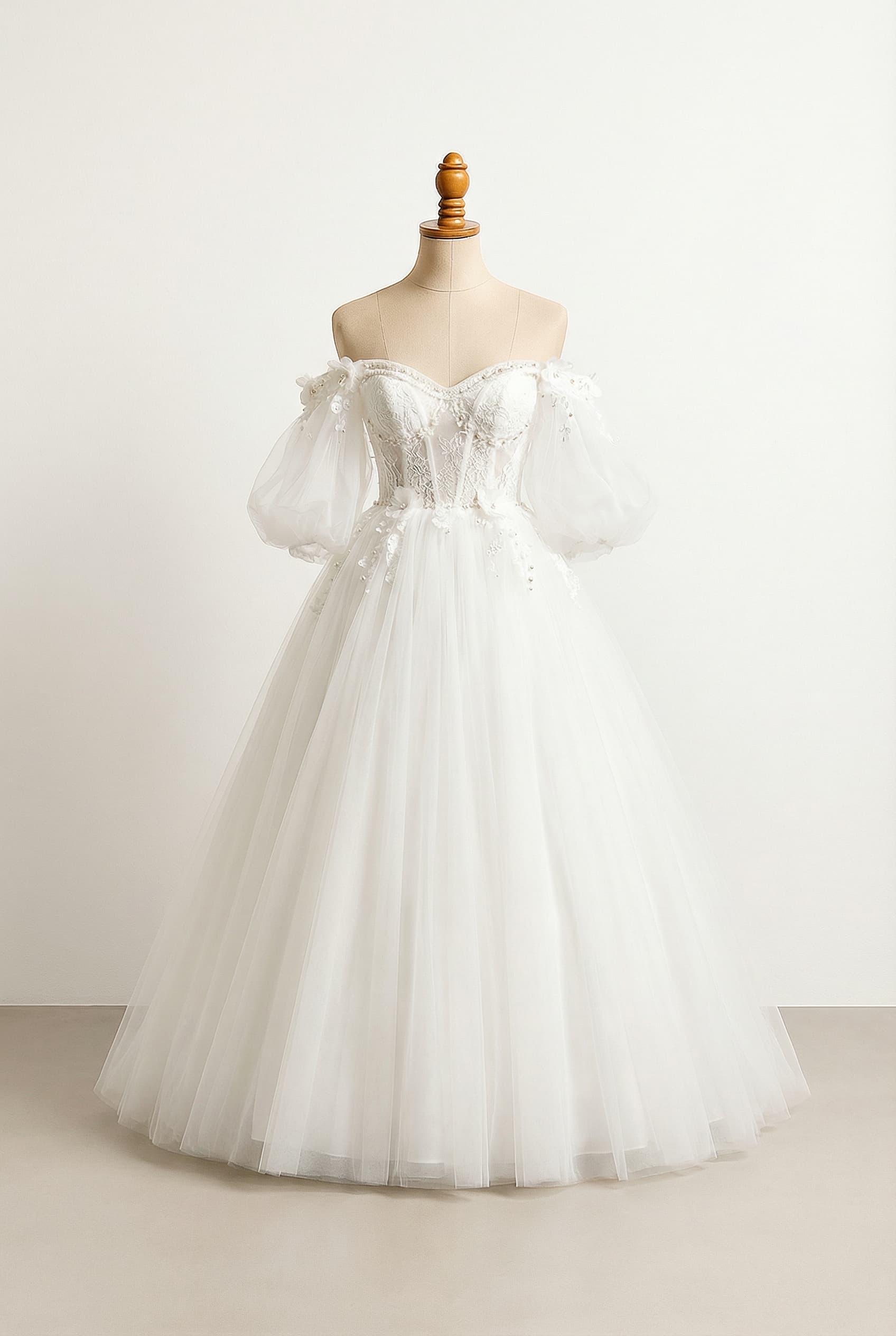 A romantic wedding dress with elegant details, featuring lace, beading, and floral appliques on the bodice.