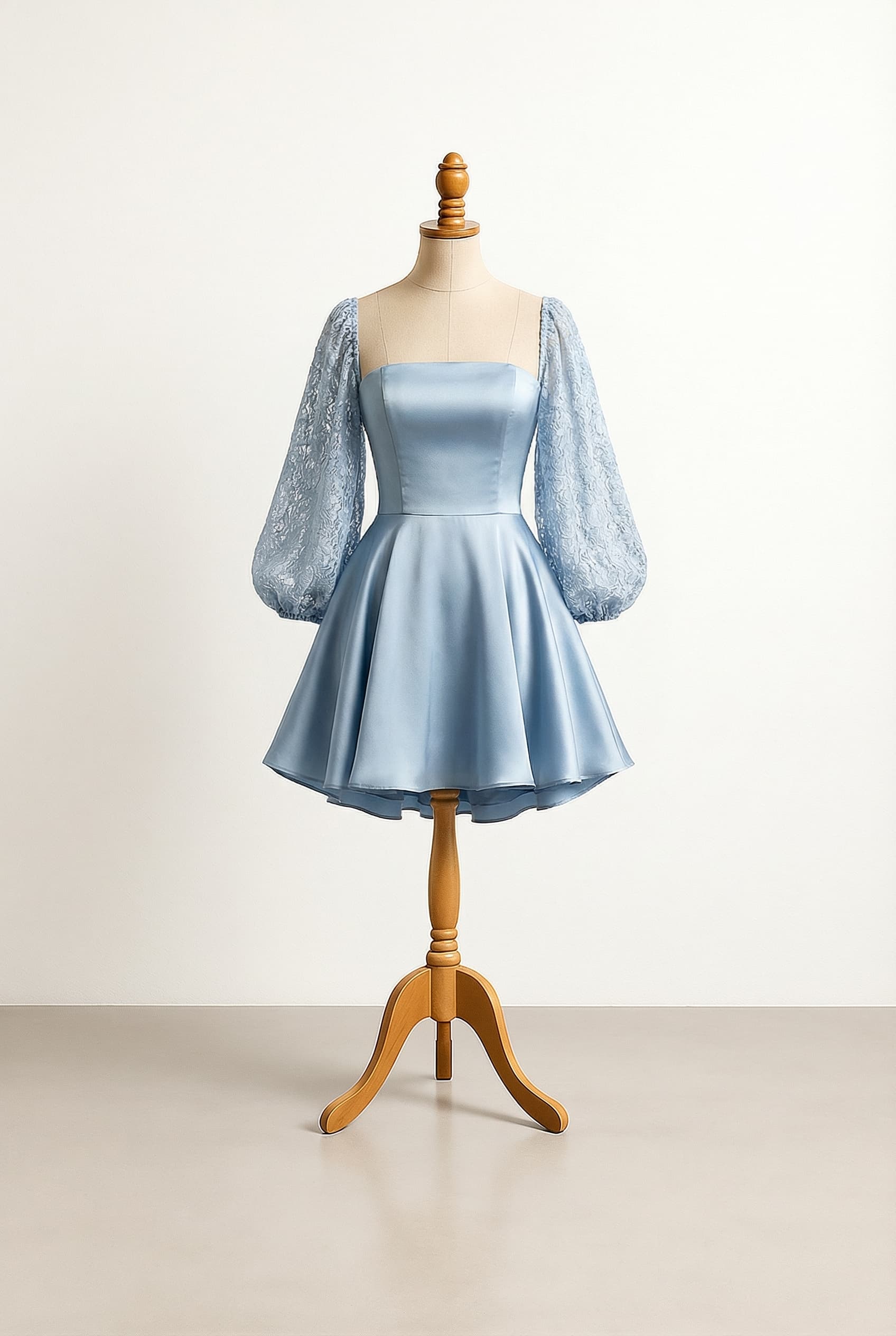 Mini dress with a skirt that poofs out in an elegant way and a tube top bodice and shoulderless sleeves in soft blue The sleeves are loose bouncy and lantern style The sleeves are soft lace and the top is silk The skirt is silk with an underlayer of silk peeking out