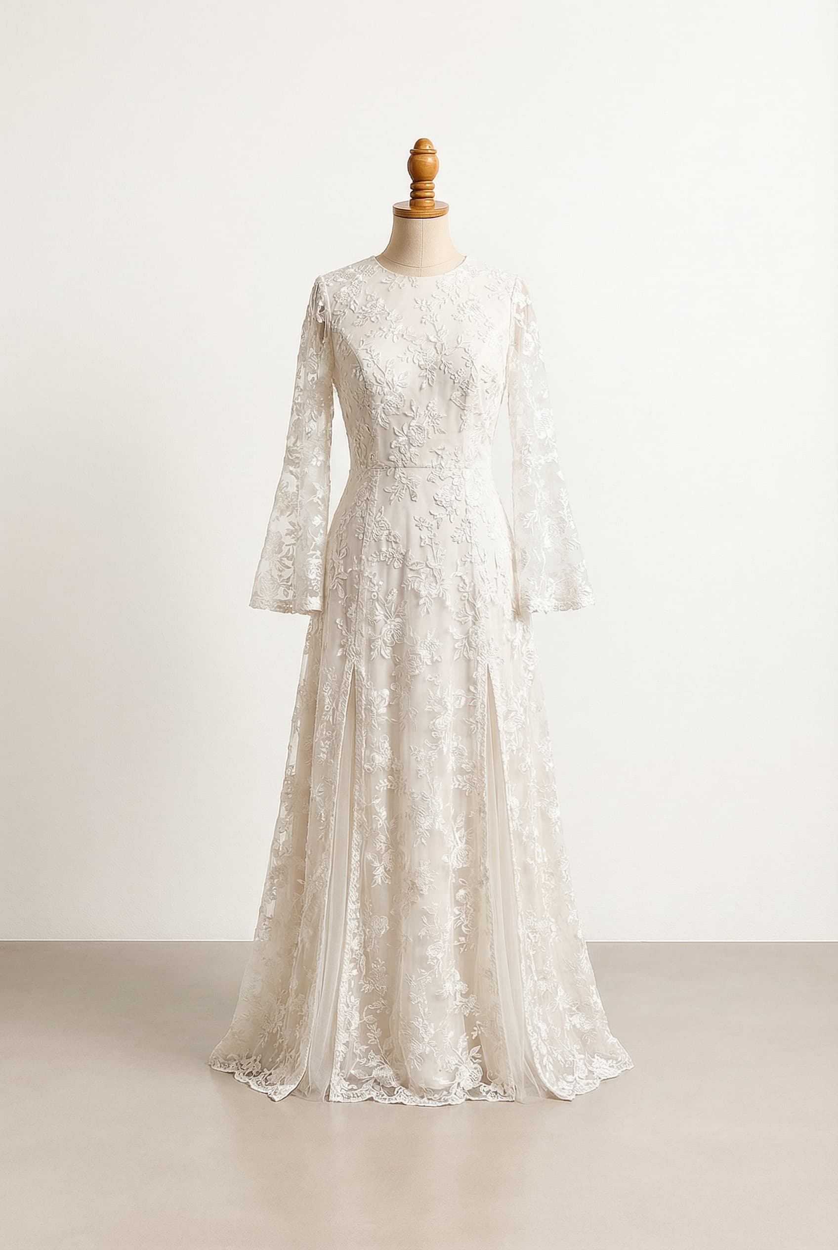 I want a balanced wedding dress with a double slit A-Line silhouette and long bell sleeves. The underskirt and sleeves should be made out of embroidered floral tulle or lace. I do not want a sweetheart neckline or a train. The back can be plain or normal no key hole