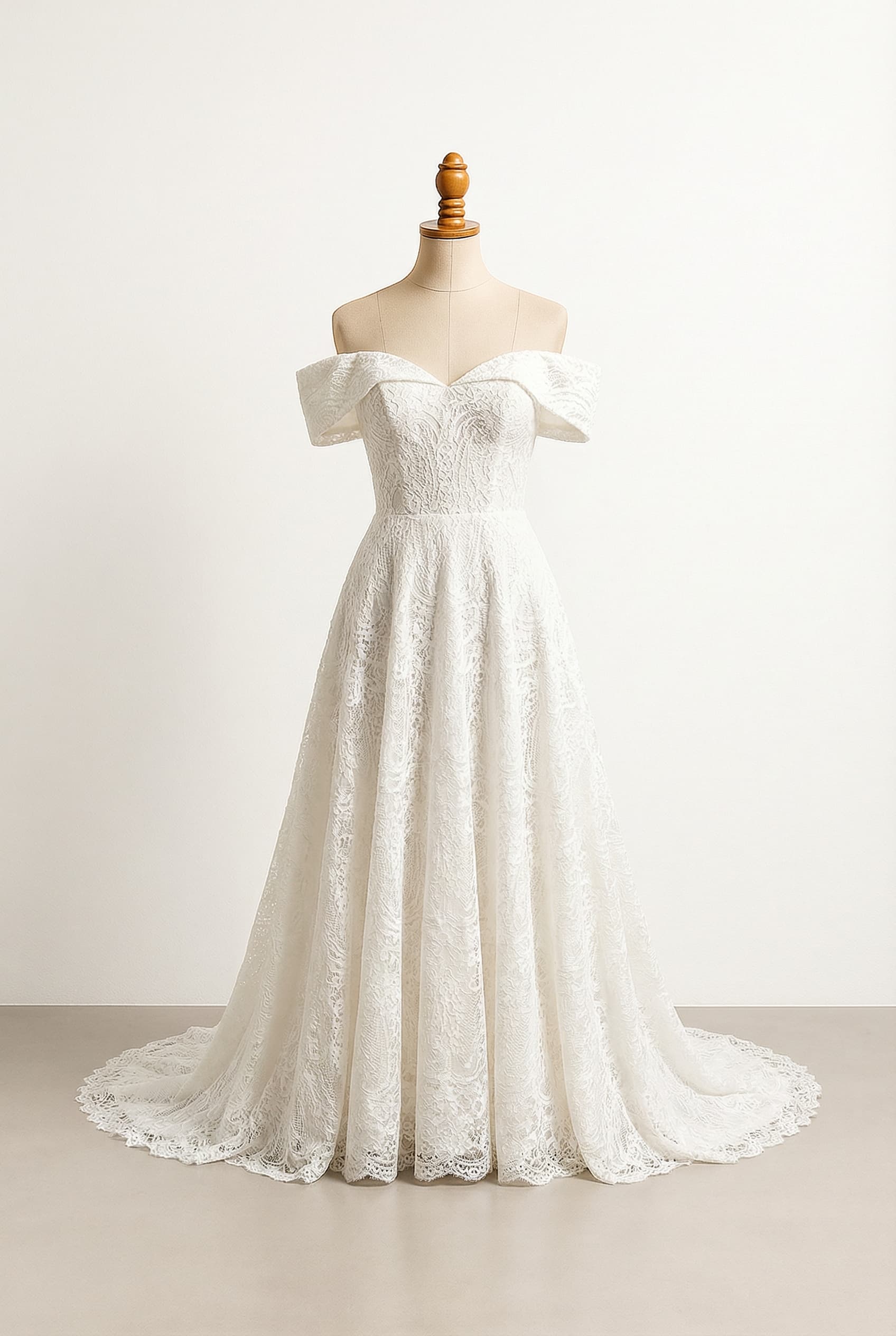 A romantic A-line wedding dress with elegant details, made of Tulle with a little bit of lace, featuring a chapel train, structured off-shoulder sleeves, and an off-shoulder neckline.