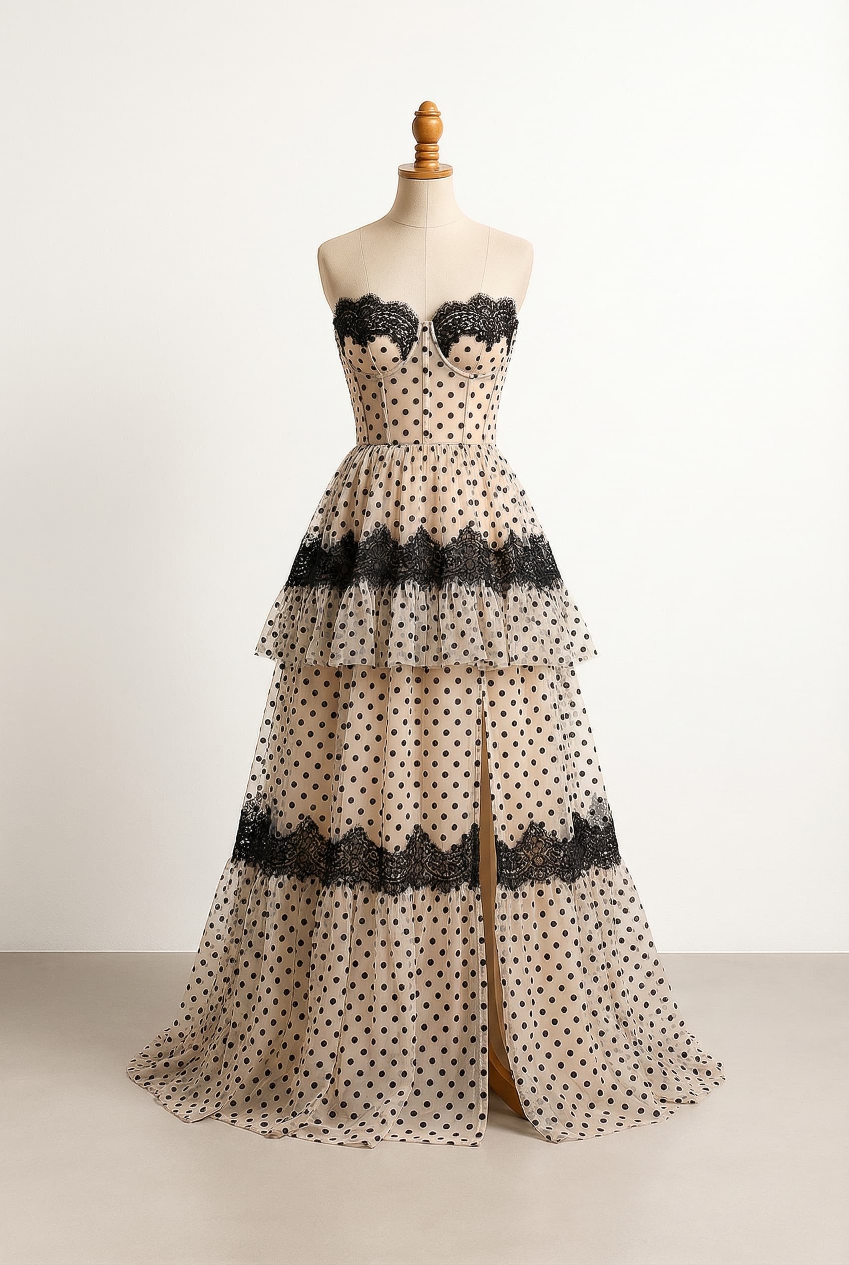 Sweetheart neckline tiered gown front slit chiffon with black polka dots corset body A-line silhouette with a cascade of layered ruffles and black lace embellishments around the sweetheart neckline floor length