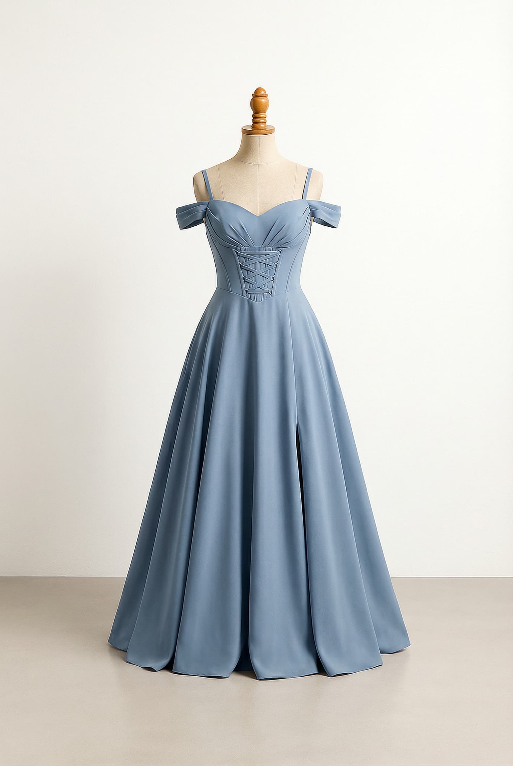 Simple dusty blue floor-length dress with a small slit no higher than mid thigh, a sweetheart neckline, delicate off the shoulder straps, and a corseted top with delicate criss-cross lacing on the front.