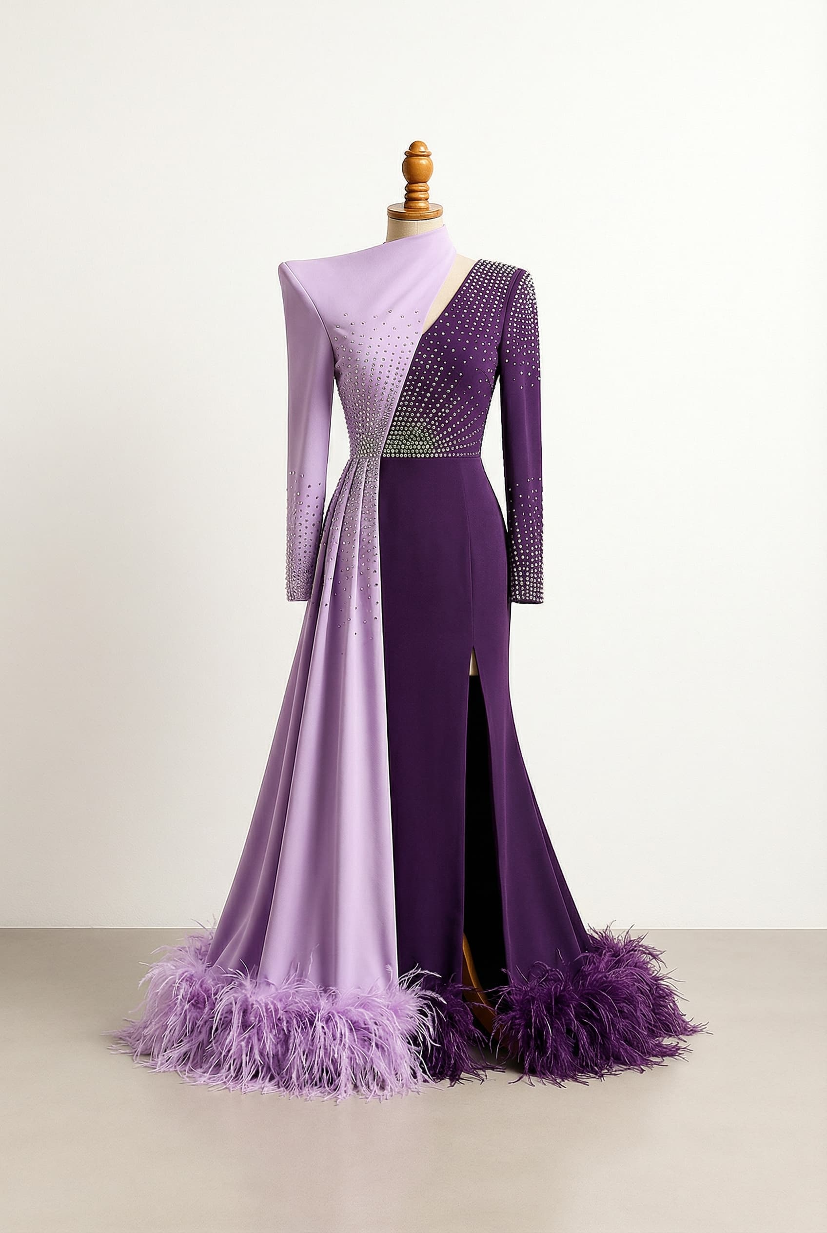 Split colored prom dress in Lavender and Dark Purple, with a long rhinestone embellished top, a side split on the right, feathers on the bottom, and an asymmetric high shoulder structure on the left.