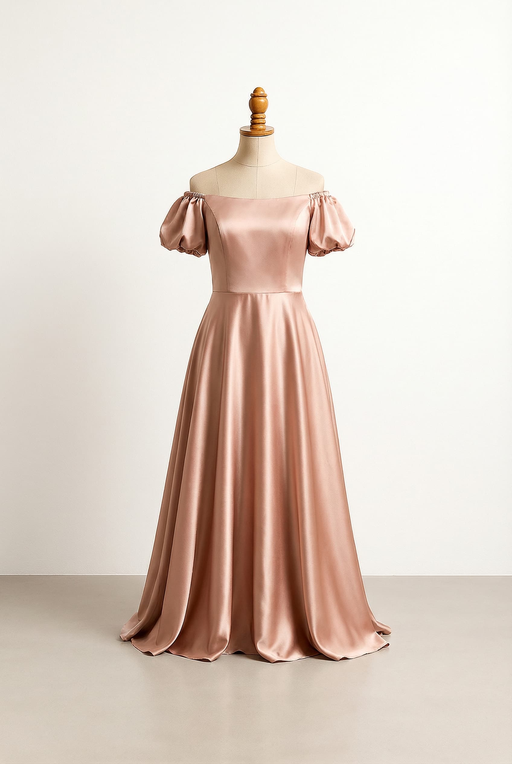 Modern princess quinceañera dress with an off-shoulder neckline, rose gold silk charmeuse fabric, puff short sleeves, a soft flowing bodice, natural waist, and a floor-length skirt.