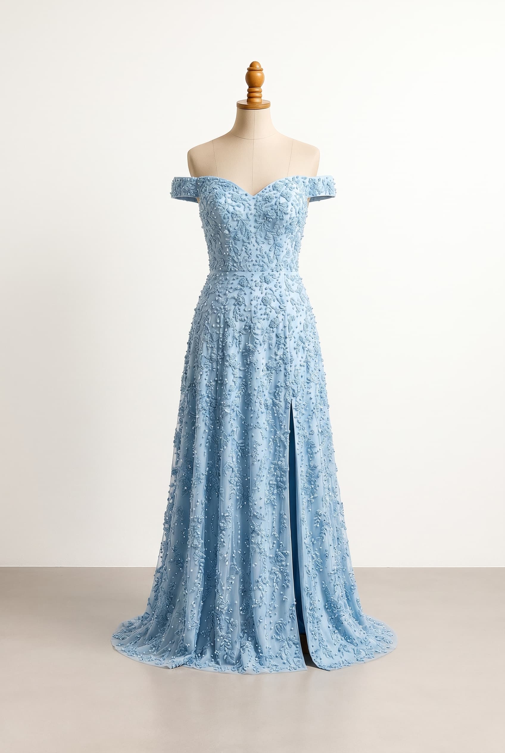 A balanced bridesmaid dress with an off-shoulder sweetheart neckline, floor-length skirt, a significantly higher slit on the left thigh. The dress features a fitted bodice with a very flowy skirt, entirely covered in light blue beaded embroidery, with no flowers, only little beads.