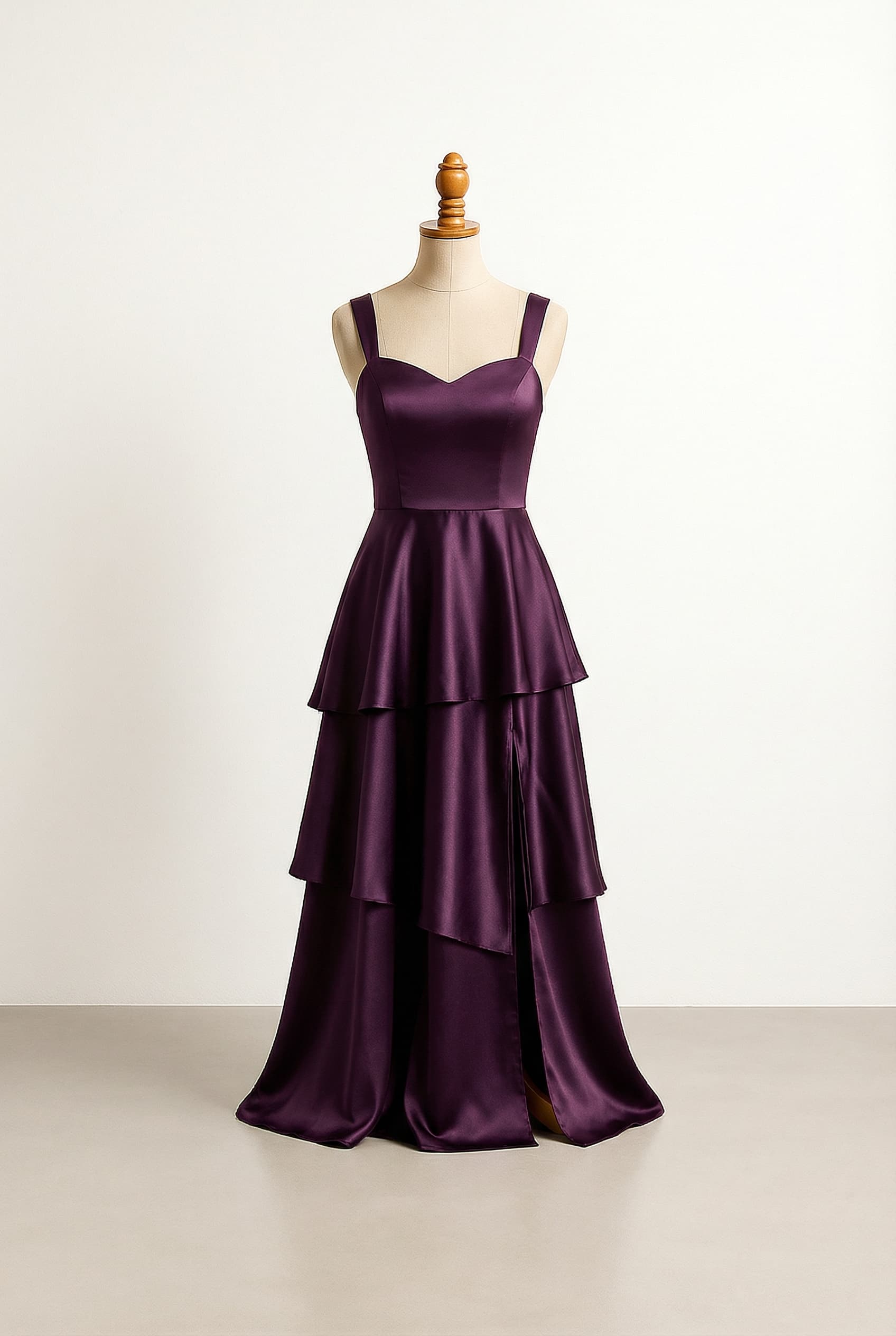 Glamorous dark purple tiered prom dress with wider straps, a sweetheart neckline, and a slit on the right side