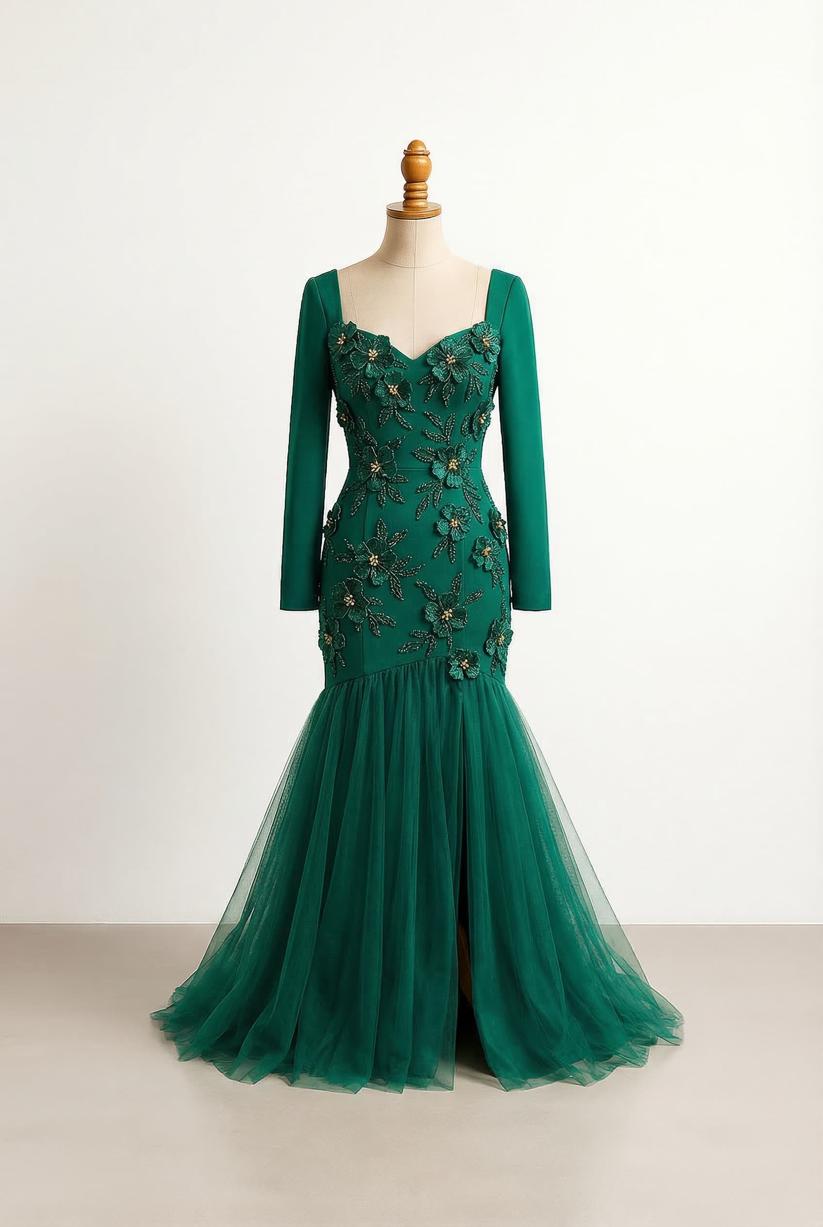 Emerald green with gold accents V - Classic V-neck opening ALine - Fitted down to the belly button then flares dramatically Long - Full length sleeves Tulle - Fine netting for volume layering and delicate details with a slit in front sweetheart neckline beaded with emerald green flowers that have gold accents on the inside of the flower no sleeves beaded dress with a slit on the bottom