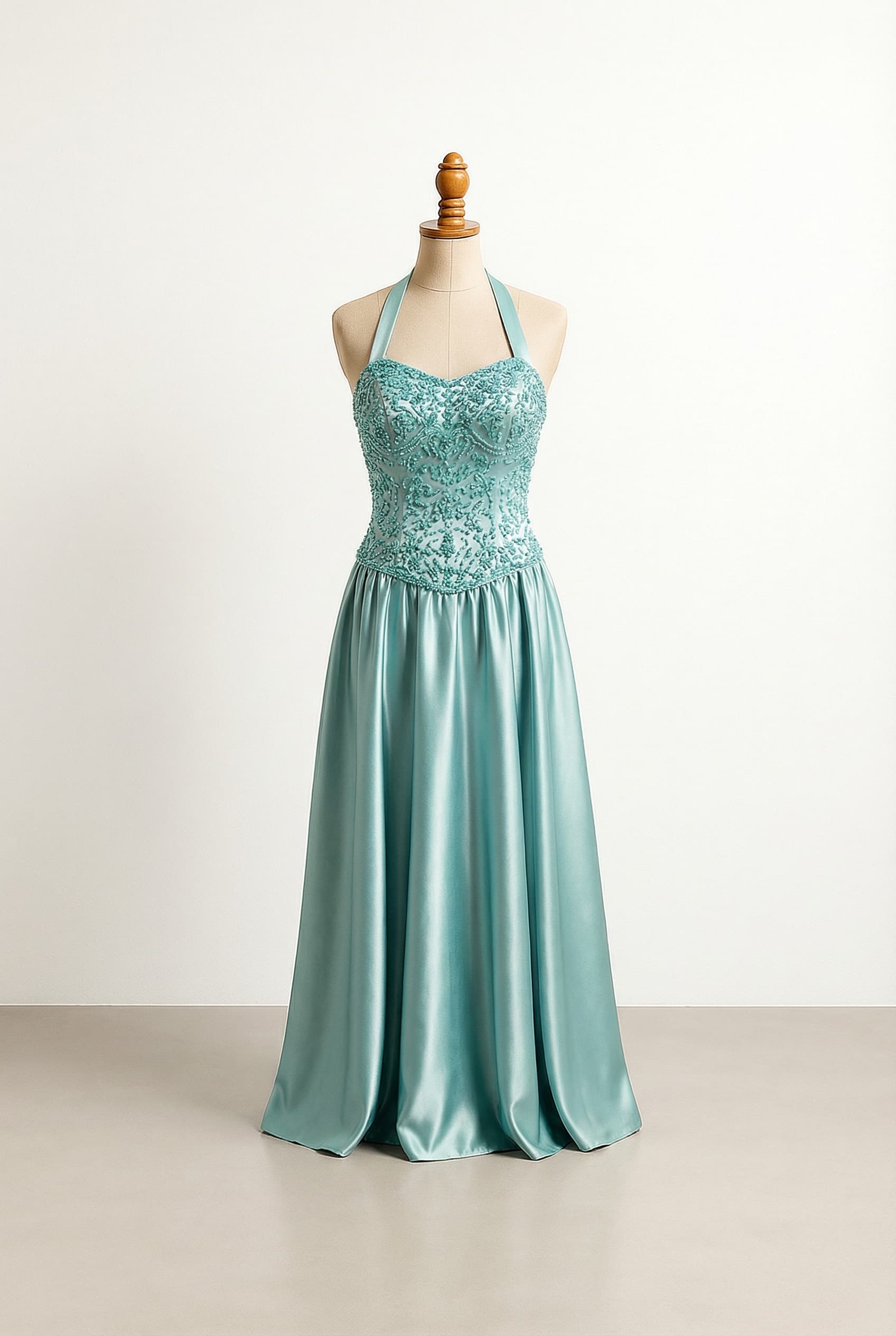 Glamorous prom dress with a halter neckline, vintage vibes, and beaded embellishments in a warm aqua color.