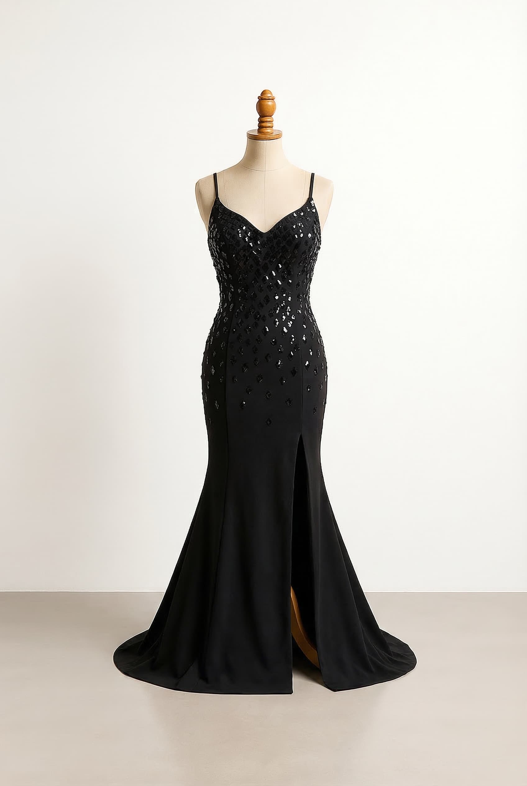 Full length prom dress with a slit on the right side black bodice with scattered black diamond gems curved downwards v-neck with spaghetti straps