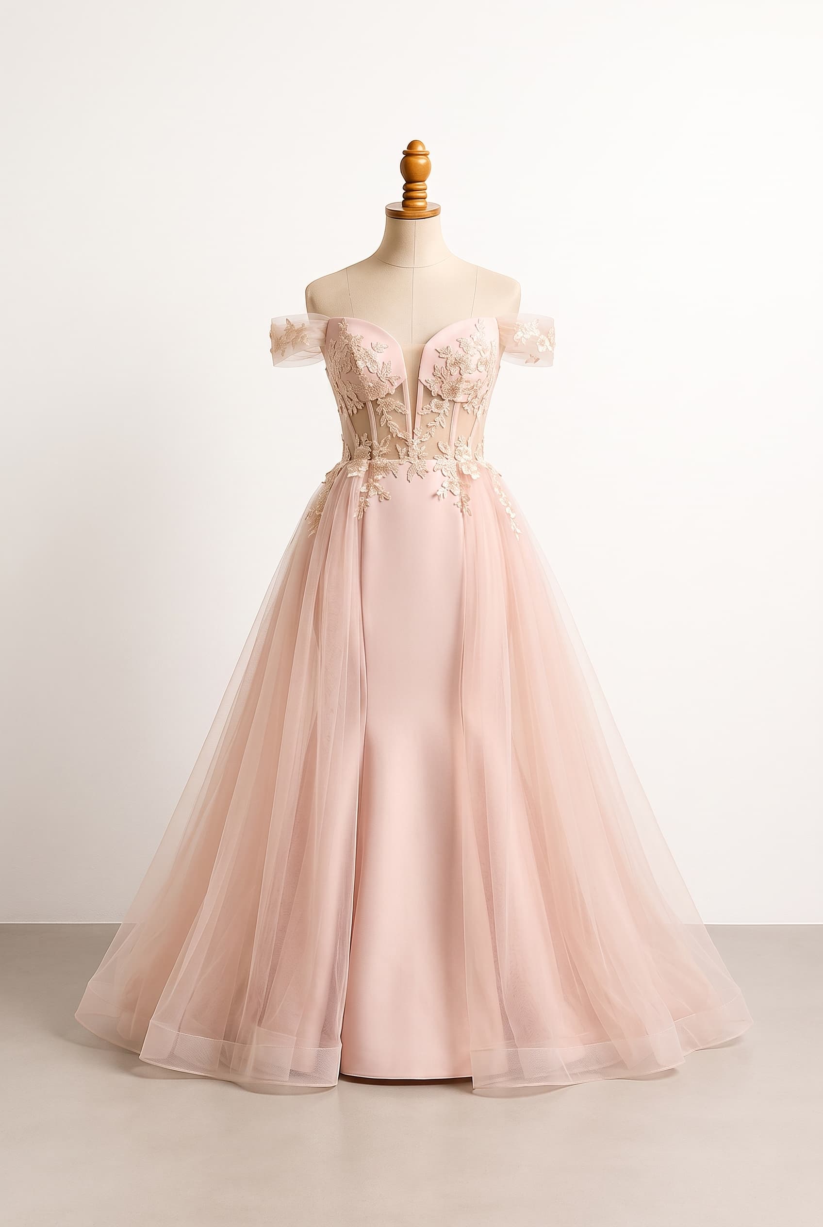 A modern quinceañera look with a refined crop-style corset bodice connected by illusion mesh to a high-waisted full skirt, delicate floral appliqué, a softly plunging neckline, and removable overskirt for a dramatic reveal; romantic and contemporary