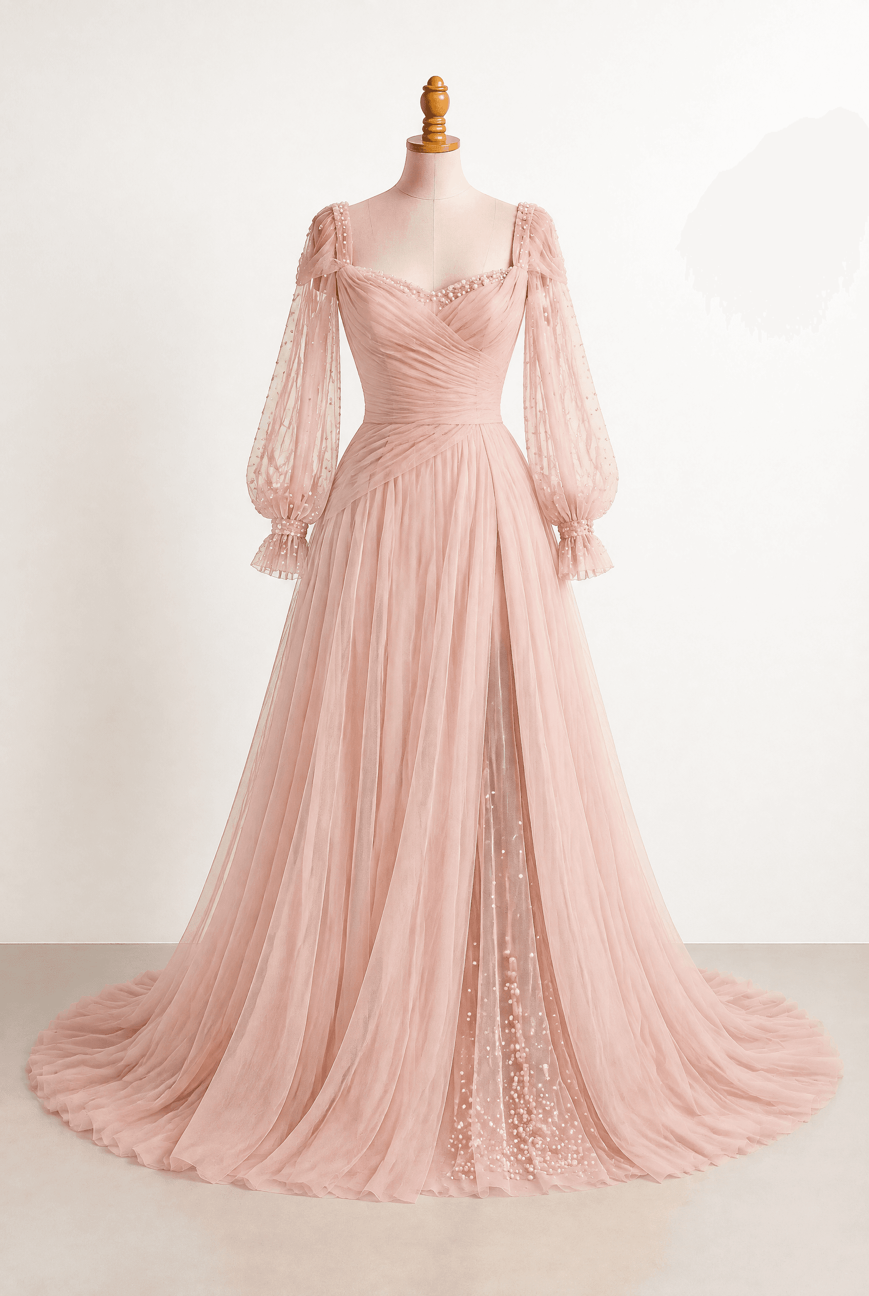 Blush pink A-line floor-length gown with a romantic train and draped back; Sheer sleeves with pearls dispersed over them; draping and pearl details at the sleeves and neckline; A slit reveals tulle with pearl clusters; Soft, flowing swish; Tulle-Shoulder Elegance