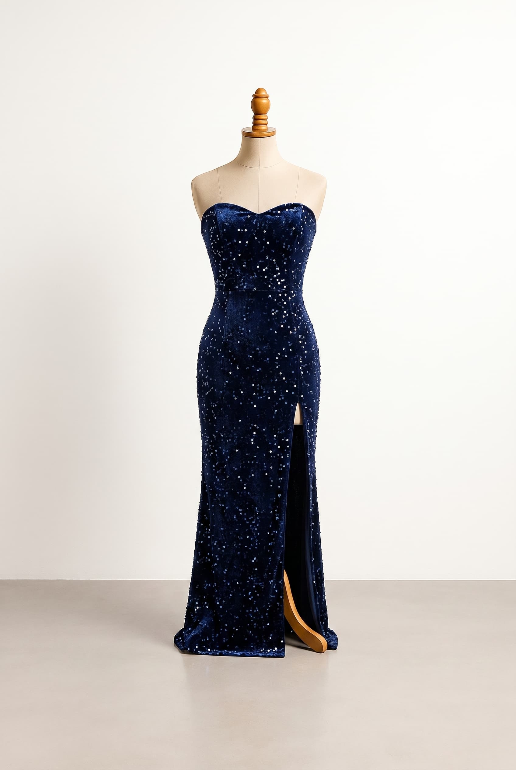 Bold, revealing prom dress with a rich sultry texture Designed for a sleek confident fit that turns heads The fabric offers a luxurious depth for a statement-making night avoid heavy or stiff fabric movement need easy to dance in priority visual drama matters most, revealing prom dress with a rich sultry texture, designed for a sleek confident fit that turns heads. The fabric offers a luxurious depth for a statement-making night. Avoid heavy or stiff fabric movement; need easy to dance in. Priority visual drama matters most. Sleeveless dark navy blue tube dress with a tight fitted silhouette, a leg slit. Finished with sparkly navy blue fabric.