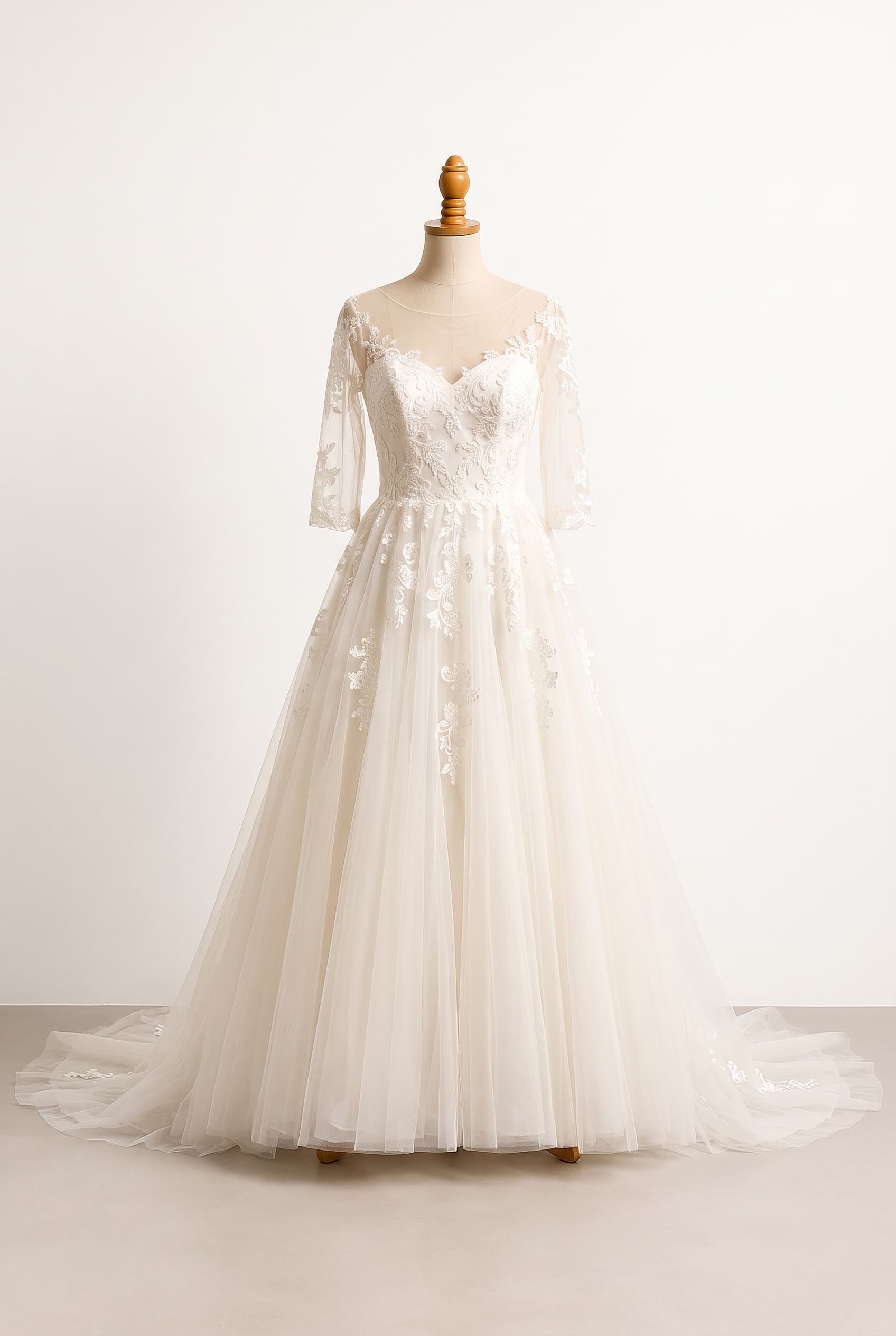 A graceful balanced wedding gown combining a defined bodice, a light full skirt, tasteful texture, and elegant coverage without feeling heavy