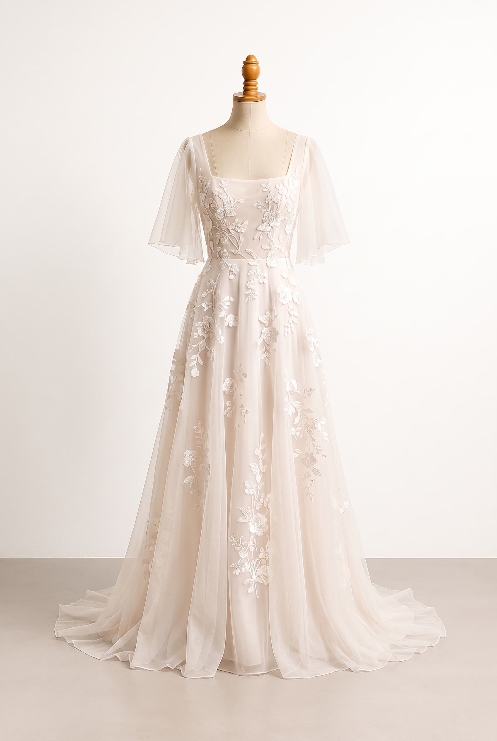 An airy, ethereal wedding dress inspired by a quiet garden, with flowing movement and botanical accents